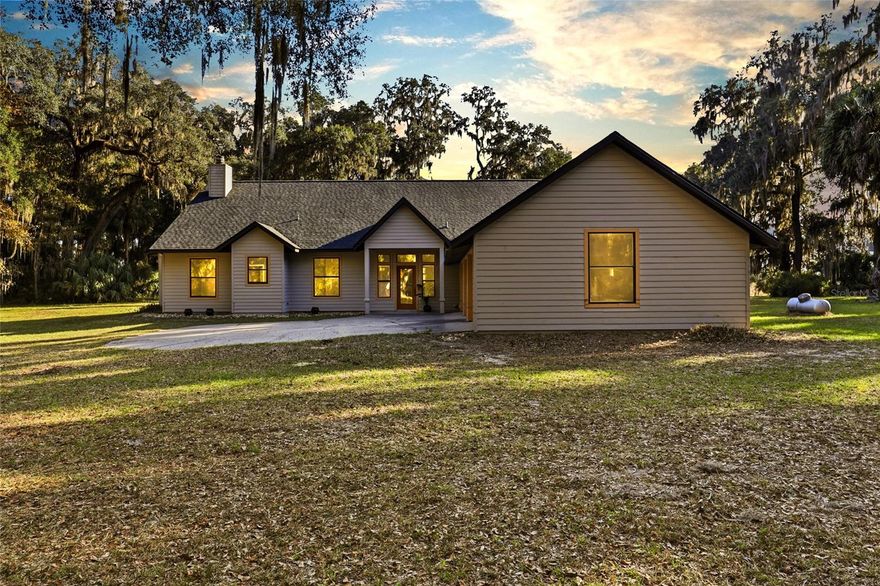 This is the dream you've been working so hard to make come true! Tucked away just minutes from Archer Road, 10524 SW 75th Way, Gainesville, FL 32608, offers a rare opportunity to own 16.25 private acres bordering the breathtaking Kanapaha Prairie — one of North Central Florida’s most pristine natural landscapes. Truly one of a kind, this prairie lover's paradise blends the best of both worlds: easy access to Gainesville’s conveniences and the peace of your own private wilderness homestead. Think deer at dawn, bass fishing in your own private pond, and breathtaking sunsets that paint the sky every evening until night takes over and the real show begins... stars, so many stars! This sprawling estate is adorned with majestic oaks draped in Spanish moss and abundant wildlife including deer and turkey — a true sanctuary for nature lovers, hunters, or anyone seeking a more grounded lifestyle. Built in 1995, this custom home features 3 bedrooms, 2.5 baths, and a open living/dining/kitchen layout designed to capture natural light with soaring vaulted ceilings, tons of windows and a wood burning fireplace. Scraped wood floors throughout the great room glow with warmth, and the impressive kitchen — complete with a gas range — is perfect for both everyday living and entertaining. Step outside to your spacious screen enclosed pool patio with hot tub, surrounded by lush greenery and the sounds of nature. An expansive primary suite offers double walk-in closets, a spa-like bath with a soaking tub, walk in shower and his-and-her vanity areas. Enjoy your morning coffee on the side screened porch or host unforgettable gatherings on the pool patio as twilight falls over the prairie. This magnificent property is zoned agricultural, making it ideal for horses, farm animals, gardening, or sustainable living. There is also an additional cleared area hidden among the oaks and ready for an accessory dwelling unit (ADU) — up to 1,700 sqft — perfect for multigenerational living, guest quarters, or rental income. With RV hookups and parking pad, this property is ready for every lifestyle. Located near Jordan Glen School/Summer Camp and just a short drive to Gainesville’s shops, restaurants, hospitals, and the University of Florida, this home delivers unmatched privacy without sacrificing convenience. Imagine hosting outdoor parties at twilight, fishing your private pond, or simply soaking in the quiet, golden beauty of your own prairie world. This is more than a home — it’s a lifestyle, a legacy, and a chance to live in harmony with nature. Schedule your private tour today and ring in the New Year with a whole new life!