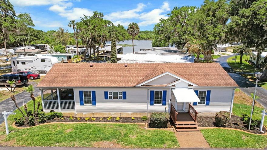 WHAT IF I TOLD YOU: $125 a month HOA fee included your WATER, SEWER, TRASH AND MOWING YOUR YARD!!! And yes there's more!! CHAIN OF LAKE ACCESS on Lake Griffin!! This community offers a marina and boat slips upon availability for a minimal fee.  It has a community fishing dock, pool, community building and so much more! This home is A RARE FIND 3 bedrooms, 2 bath beautiful home with split bedroom plan, open concept with an AMAZING KITCHEN! Ample cabinetry with closet pantry featuring pull outs, Counter space that goes on and on!! Inside laundry! And the most GORGEOUS SCREENED/COVERED LANAI! Spend your outdoor time overlooking a view of the water at the community boat ramp. Situated on a corner lot, One owner!  Reroof 2019, HVAC March 2026, HWH 2006 Don't miss this beautiful home in an active, low HOA community! See it and fall in love!