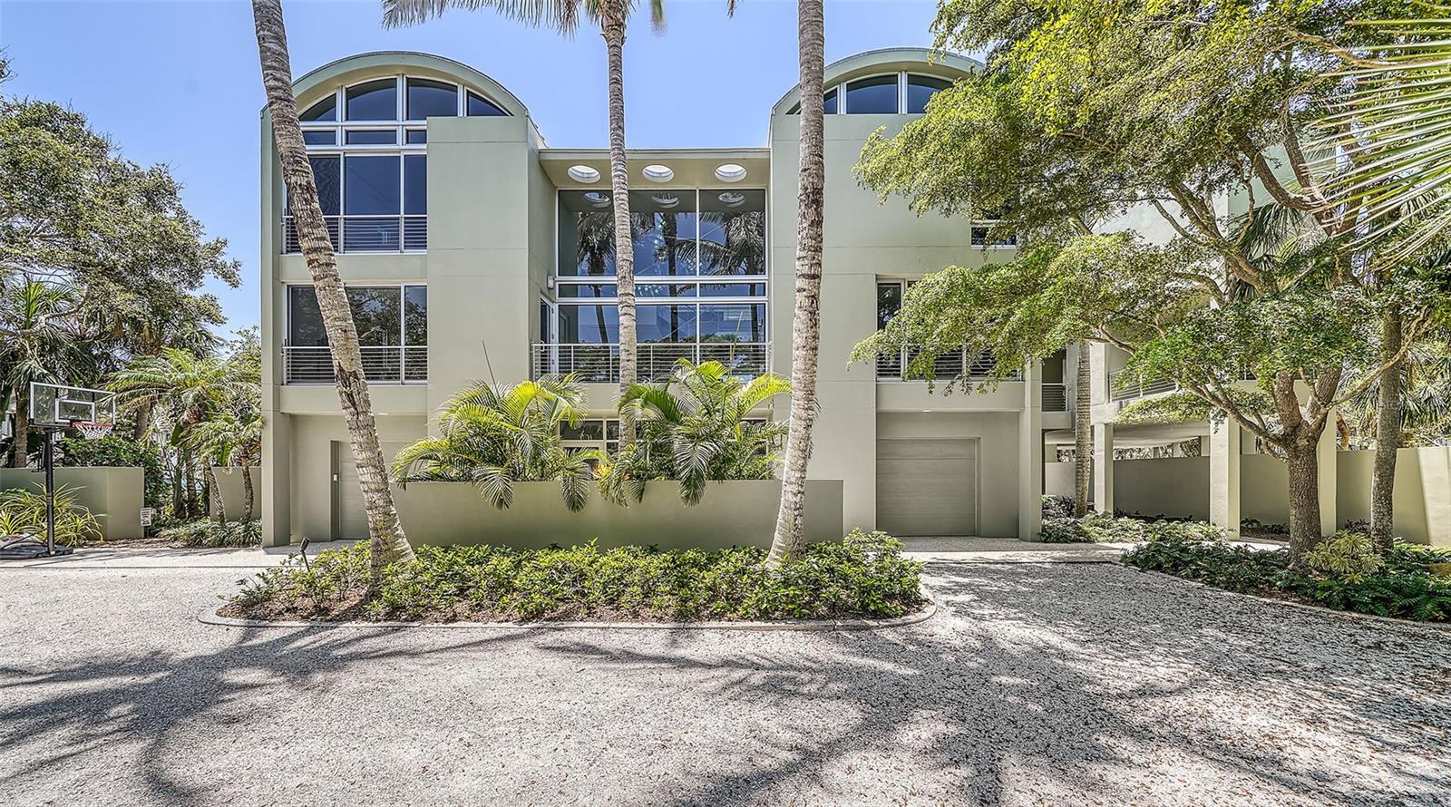 GULF TO BAY FOUR-FIVE BEDROOM CONTEMPORARY HOME INCLUDES PRIVATE BEACH, POOL, GYM OFFICE & DOCK! Located on Manasota Key, the Island that has Kept its Florida Charms! Offering a Multi-Generational Profile! Enjoy Fine dining, Casual Restaurants, Boutiques, Artist Retreats, and a Private Resort on the Island! Includes 1.71 Acres on Lemon Bay, Dock with Two Boat Lifts. Manasota Key has the Convenience of Two Bridges Connecting to the Mainland. The Homes Famed Builder and Architect Combined their Talents While Creating This Iconic Residence! * A Tri-level Home Offering an Open Floor Plan Concept that is Divisionally Designed to Present Separate but Fluid Living Areas * Lighting and Window Treatments All work Electronically * 5 Star Kitchen Includes State – Of – The – Art Appliances * Flooring with Glass Insets to the Kitchen, and Dining Area * Eight Balconies Open to the Sounds of Swaying Palms and the Rhythm of The Sea * Walls of Windows Allow Sunrise and Sunset Views * Great Room Fireplace * Charming Family Room Fully Equipped with a Wet Bar/Refrigerator. The Generous Master Suite is Located on a Separate Wing of the Homes Main Living Level. Offering Tremendous living Space, with a Private Balcony and Spiral Staircase to the Pool. Included are the Huge Shower, Spa size Jacuzzi Tub, Double Vanity, Lavatory, Dressing Area and Walk-In Closet. All Other Bedrooms, Office and Gym are located on the Second Level. Office & Gym may be combined to create a 2nd Master Suite. Pool and Spa Decking Include a Cascading Waterfall. Enjoy Multi-Areas for Shading and Poolside Entertaining. Easy to Add an Ultimate Summer Kitchen* Easy Care Native Landscaping * Privacy Wall & Private Entrance Gate with Security Throughout Home* A Boardwalk to the Beach Includes a Deck to Enjoy Magnificent Sunsets!! Across the Road You will Own Over an Acre of Bayfront Property with a Whimsical Dock. Electric, Water In place & Two Boatlifts. Two Garages, Plentiful Cabinetry, and a 2nd Laundry for Pool Side Convenience. An Extraordinary Gulf to Bay Residence Offering A “Private Sanctuary” For You and Your Family!