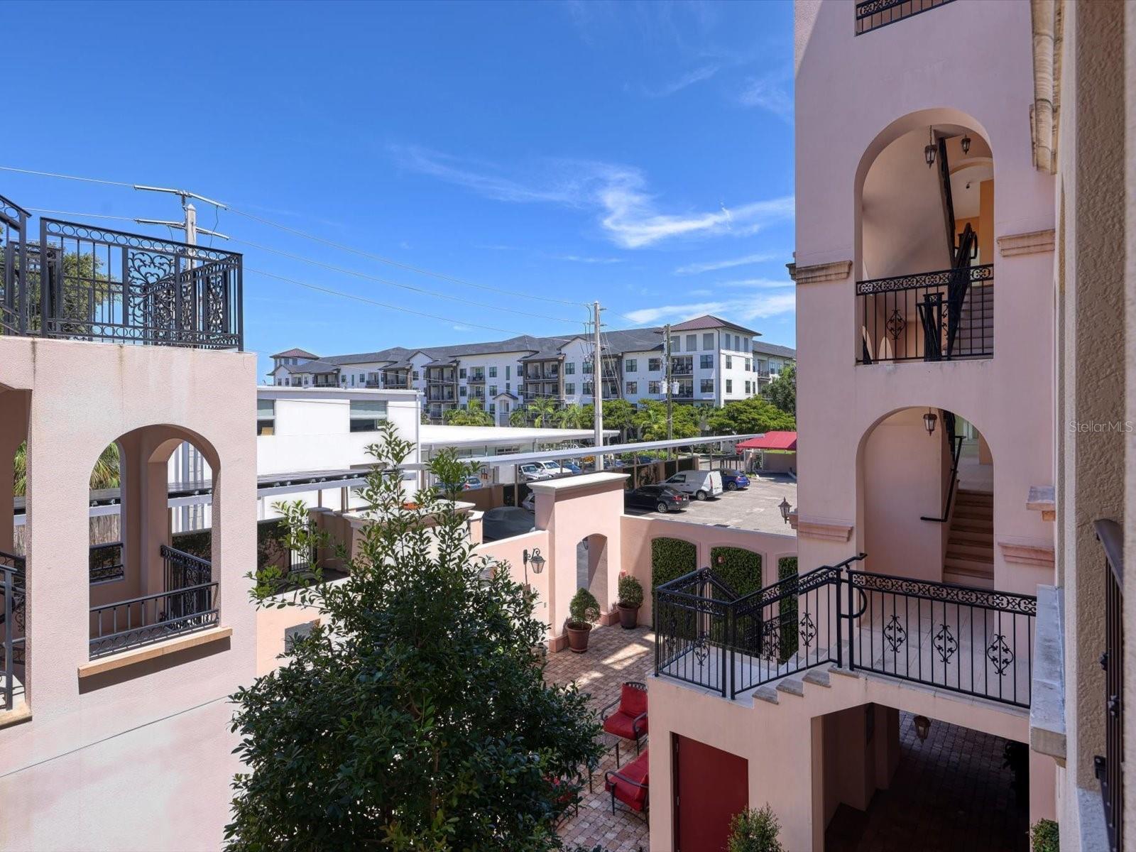 Unfurnished Annual Rental Available 7/19/25. This beautiful two-bedroom, two-bath condominium in downtown Sarasota’s Rosemary District. Located in the gated European-styled Courtyard at Citrus Square community, it is an easy stroll to shopping, dining, entertainment, and the waterfront. It was built in 2019 with the highest standards of construction and the latest hurricane codes. The concrete block between units, hurricane standard windows, and additional ultra-quiet sound abatement, creates a peaceful environment. This condo has an open floor plan with soaring 10’ ceilings. French doors open from the living area to a balcony, allowing residents to bring the outdoors in. The spacious courtyard, with comfy seating and a gas fireplace, is a wonderful spot to relax or meet friends. The bright kitchen includes stainless steel appliances and all-wood cabinetry. The light-filled master suite includes a walk-in closet and ensuite bathroom. This bedroom will accommodate a king-sized bed, and the bathroom includes an extra-large walk-in frameless glass shower. The second bedroom could easily double as a den. The second bathroom includes a tub/shower combination and some extra storage space. The laundry room has full sized stackable washer and dryer. The carport is conveniently located within the gated community. Convenient to the UTC Mall, shopping, restaurants, and entertainment. Easy access to I-75, Sarasota Airport, Tampa International Airport, and Tampa/St. Petersburg, and world class beaches.