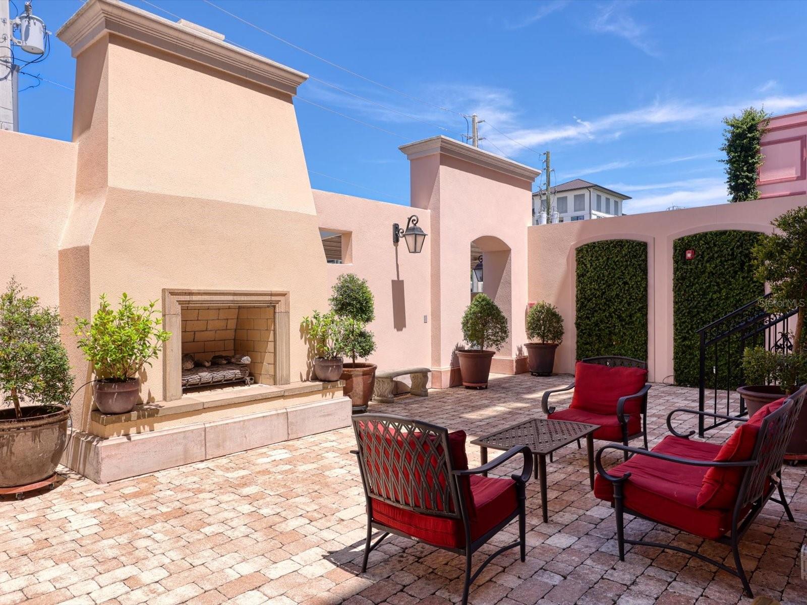 Unfurnished Annual Rental Available 7/19/25. This beautiful two-bedroom, two-bath condominium in downtown Sarasota’s Rosemary District. Located in the gated European-styled Courtyard at Citrus Square community, it is an easy stroll to shopping, dining, entertainment, and the waterfront. It was built in 2019 with the highest standards of construction and the latest hurricane codes. The concrete block between units, hurricane standard windows, and additional ultra-quiet sound abatement, creates a peaceful environment. This condo has an open floor plan with soaring 10’ ceilings. French doors open from the living area to a balcony, allowing residents to bring the outdoors in. The spacious courtyard, with comfy seating and a gas fireplace, is a wonderful spot to relax or meet friends. The bright kitchen includes stainless steel appliances and all-wood cabinetry. The light-filled master suite includes a walk-in closet and ensuite bathroom. This bedroom will accommodate a king-sized bed, and the bathroom includes an extra-large walk-in frameless glass shower. The second bedroom could easily double as a den. The second bathroom includes a tub/shower combination and some extra storage space. The laundry room has full sized stackable washer and dryer. The carport is conveniently located within the gated community. Convenient to the UTC Mall, shopping, restaurants, and entertainment. Easy access to I-75, Sarasota Airport, Tampa International Airport, and Tampa/St. Petersburg, and world class beaches.