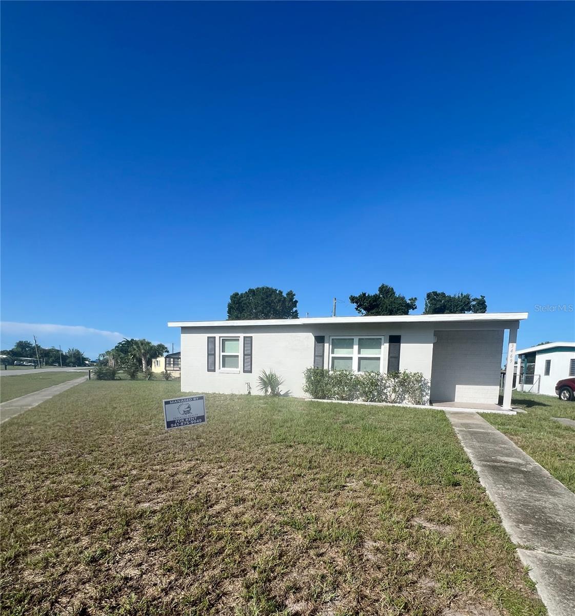2 Bedroom 1 bathroom house with 804 square foot of living area. The home is tiled throughout with ceiling fans, blinds, refrigerator and range. There is a large back yard with covered lanai. The house is available for rent immediately on a 1-year lease. Lawn included.