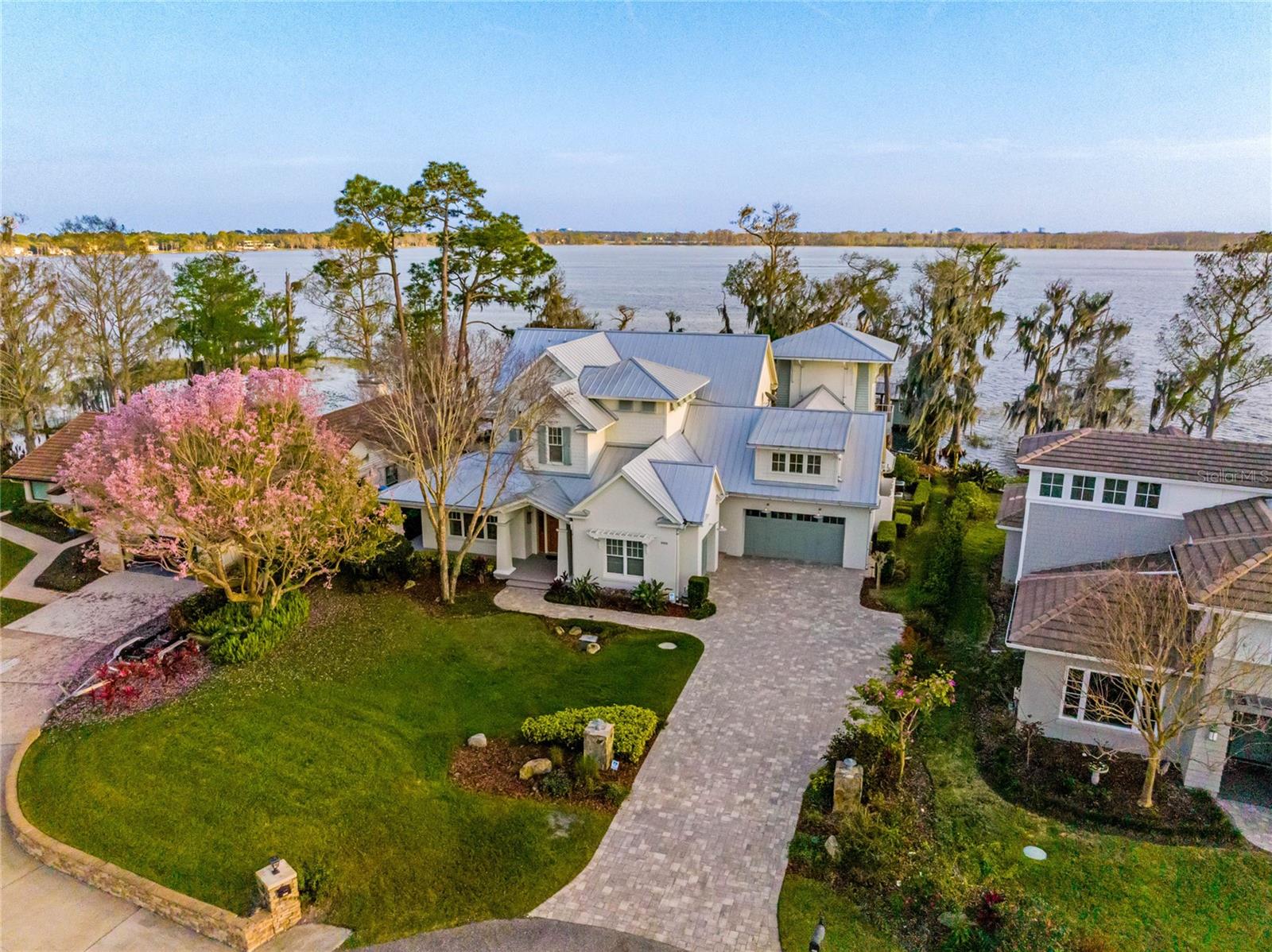 Welcome to “Seaglass” a ~ Spectacular ~ Custom ~ Lakefront Estate ~on the Famed BUTLER CHAIN of LAKES. Perfectly nestled on a Rare PENINSULA lot, at the End of the cul-de-sac, offering DOUBLE WATER VIEWS. Lake Tibet views in front, and Breathtaking, Long Range SOUTHERN EXPOSURE views of Lake Sheen in back allowing you to Wake up each morning to awe-inspiring SUNRISES and end each day viewing Captivating SUNSETS. Panoramic Lake Views and FIREWORKS from Disney, Universal and Sea World to dazzle you. You will not find a more gorgeous view on the pristine Butler Chain of Lakes. Enjoy Water Sports, Boating, Fishing and more on over 4,700 Acres throughout 11 interconnected Lakes of the Butler Chain, Classified as Florida Outstanding Waters.
This One of a Kind, Architectural Coastal Masterpiece will WOW you at every turn.
From the moment you walk through the front door you will know you have arrived at a truly Exceptional home with plenty of room for everyone with just under 6,000 sq.ft. of living, 5 Generous Sized Bedrooms, Plus a Theater Room, Gym, Two Story Tower Retreat, and 5 ½ Bathrooms.
Designed with attention to detail, from the handmade Dove Tail Solid Wood Cabinetry to the Pennsylvania Bluestone Tower, a beacon on the Chain of Lakes, to the Designer Light Fixtures, no bell or whistle was overlooked.
The Kitchen features Top of the Line Appliances, Two Built In - Cabinet Paneled - Refrigerator Freezers, Gas Range with Dual Ovens, Double Stack - Soft Close - Custom Cabinets, Tin Ceiling, Pull out Spice & Bottle Storage, a walk in Pantry, a Butler Pantry with an Ice Maker & Wine Refrigerator, and a built in circular dining space overlooking the Expansive Family room with a Vaulted Wood Ceiling and Unparalleled views of the Pool and the Lake beyond.
The Amazing Primary Suite is on the first floor offering exquisite lake views and French doors out to the Pool, 2 Custom Walk In Closets and a Spa Like Primary Bathroom complete with a Jetted Tub and Spa Jetted Shower. Head up the private brick stairway leading to your Two Story RETREAT TOWER with Incredible Panoramic Lake Views, 2 Balconies, Two Story Windows and a loft area.
Incredible Home Theater all Customized for the room. Delightful built-ins and unexpected spaces are found throughout the home. Oversized bedrooms feature walk in closets with custom built ins. A Huge Laundry Room Downstairs, and an additional Laundry Room Upstairs, Tons of Storage, a WHOLE HOME GENERATOR and so much more!
Enjoy Alfresco Dining on the Covered Lanai complete with a decadent Summer Kitchen. Unwind in the Sparkling HEATED Salt System POOL and INFINITY EDGE SPA. Relax under the stars next to your fire pit on the Expansive Lakeside Deck. Rare “Grandfathered” Enclosed BOATHOUSE, Boat Lift and Freshly Painted Dock. Over 100 Feet of Spectacular Butler Chain of Lakes Frontage and a Superior Rip Rap Seawall.
Premier Location between Disney Theme Parks and Windermere an affluent yet quaint Town with weekly farmers markets, food truck & seasonal events. Just minutes to upscale shopping, fine dining, world class golfing & Orlando International Airport. Welcome Home to Your Own Personal Florida Paradise!