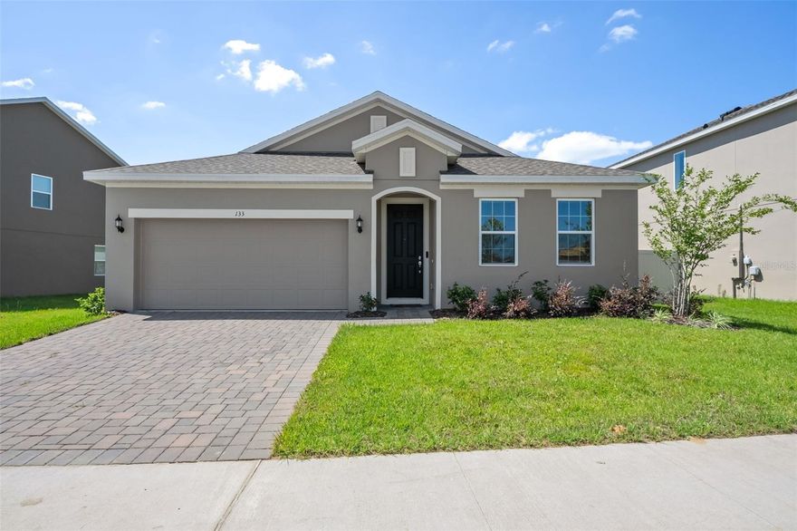 FHA ASSUMABLE 5.6% INTEREST RATE! Welcome home to 133 Juno Drive located in the community of Preserve at Sunrise. This home is new construction WITHOUT THE WAIT, plus many after-market upgrades that you can’t find in a new construction home. Built in 2022, this floor plan is known as the Kensington Flex. It offers 4 bedrooms, 2 bathrooms, an office and over 2,000 square feet. The standout feature of the Kensington Flex floor plan is the 3-way split for the bedrooms. This maximizes every inch of square footage and offers privacy for each bedroom. The kitchen is open-concept to the living room and dining room. It boasts an over-sized kitchen island, quartz counter tops, 42” white cabinets and stainless steel appliances. The primary bedroom is located at the back of the home and off the living room. It offers dual vanity sinks, a large walk-in closet and a Kohler smart shower! Upgrades include but are not limited to: blinds, windows treatments, high energy efficiency window tint, ADT alarm system and the privacy fence. The lanai overlooks the beautiful and fully fenced backyard! The Preserve at Sunrise overlooks the Palatlakaha River Watershed conservation area. The front yard of this home overlooks the conservation views and makes it the perfect setting to call home. The community also offers amenities, such as: fishing pier, playground, resort-style pool, walking paths and more. Located less than 10 minutes to highway 50, Groveland is one of the fastest growing communities in the area. You have easy access in Clermont, Winter Garden, Orlando and surrounding. Call today to schedule a private tour.