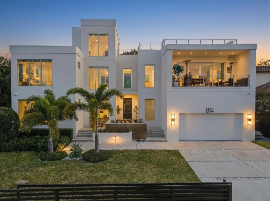 This absolutely exquisite, state-of-the-art modern residence on Davis Islands was built by Forge Building Company and showcases exceptional craftsmanship and design throughout. This stunning home features 5 bedrooms, 4 full bathrooms, 3 half bathrooms, and a spectacular rooftop terrace.Upon entering, you’re immediately greeted by a dramatic floating wood staircase and a striking three-sided linear fireplace that elegantly separates the family and dining areas. The open-concept kitchen and living space overlook the beautiful lanai, complete with an outdoor kitchen, gorgeous pool and spa, and a seamless indoor-outdoor sound system—perfect for entertaining.The chef’s kitchen is a true showpiece, featuring Calacatta Michelangelo marble countertops and backsplash, premium Wolf and Sub-Zero appliances, a Sub-Zero wine column, and a hidden walk-in pantry conveniently located adjacent to the custom-built drop zone just off the garage.The first floor also offers a spacious entertainment and game room with a built-in bar, providing the ideal setting for hosting guests, game nights, and watching your favorite teams. A private first-floor bedroom with a separate full bathroom offers flexibility for guests or a home office.Ascending the floating staircase or private elevator to the second floor, you’ll find the expansive primary suite, complete with a custom built-in bed frame and headboard, a breathtaking spa-inspired bathroom, and large sliding glass doors that open to a private balcony with stunning airport and water views. Wide hallways filled with natural light lead to 3 additional bedrooms, a spacious Jack-and-Jill bathroom, and a well-appointed laundry room.The third floor features a half bathroom and an incredible rooftop terrace, already prepped for a built-in full bar and offering panoramic views—an extraordinary space for entertaining or relaxing above it all.Additional features include a full Control4 home automation system, in-wall and in-ceiling surround sound, energy-efficient spray foam insulation, multiple Trane A/C systems, a private elevator, 10-foot ceilings on all floors, Level 5 drywall, wide-plank white oak flooring throughout, custom-fabricated railings, anodized aluminum windows and doors, and floor-to-ceiling windows that flood the home with natural light.Enjoy the convenience of taking your golf cart to the Village, where you’ll find an array of restaurants, shops, and bars. Davis Islands also offers bike paths, baseball fields, tennis courts, a historic pool, dog parks, a beach, a public marina, and its own airport. With a short commute to Downtown Tampa, Water Street, Sparkman Wharf, and the Tampa Riverwalk, this home offers not just a residence—but an extraordinary lifestyle.