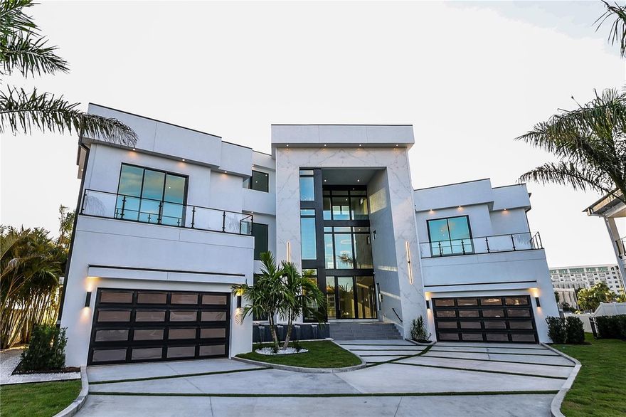 Tulia Home Designs new Contemporary construction offering open Bay Splendor in Beach Park. Built to exacting standards with state-of-the-art design, smart home technology, refined finishes and energy efficiency. Enjoy spectacular open Bay views with exceptional outdoor living and entertaining areas, custom pool and spa, outdoor kitchen, fire features, sun deck and open water access beyond. The home features 7 bedrooms, 8 and 1 half baths, plus Office, Media Room and Home Gym, Massage Room, game room and bonus room, along with a full wet bar and Wine Cellar. A custom Chef's kitchen boasts quartz counter tops, waterfall island, custom cabinetry, Wolf® gas appliances and walk-in pantry. Additional appointments include a 38-foot floating staircase, 8-car garage capacity (room for lifts), expansive terraces, Hardie exterior, with imported Italian porcelain tile, impact windows, elevator, Elan Smart Home System and custom closets throughout. Located in a top-rated school district and convenient to Westshore and International Malls, Tampa International Airport, shopping and dining. Floor Plans available.