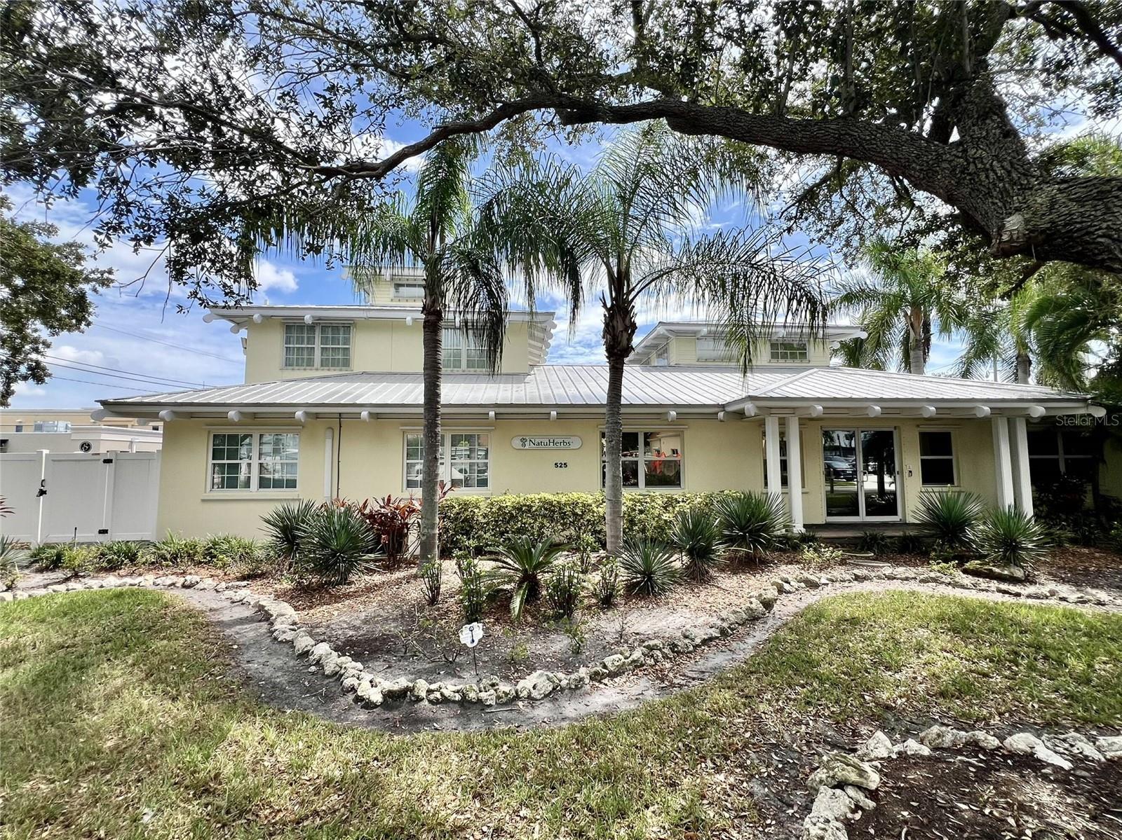 Professional Office with Warehouse Downtown Bradenton
525 8th Street W is a desirable 4,324 +/- sf freestanding office/warehouse building conveniently located Downtown City of Bradenton. The 13,750 +/- sf property has convenient parking, excellent visibility and easy access from 8th Street W along with access from 7th Street W. The property is zoned T 6 Urban Core with many desirable permitted uses including but not limited to medical uses and professional offices. The building offers divided office and warehouse space. The office space has a nice character and feel and is well appointed with 10+ office spaces located on the ground floor and upper loft area. The modern contemporary design features double glass entrance doors leading to a formal lobby and reception area and a large conference center. There are both Men’s and Women’s bathrooms with showers on the first floor. The well-maintained building has ample light due to high ceilings and the center loft area along with tongue and grove wood plank ceilings, a circular staircase to the loft above, and a central vacuum system. The warehouse features a 12’ high by 16’ wide roll up door opening to the rear of the building. Outside the building has a Key West style architectural with lush landscaping with 18+ / - parking spaces. There is also a Generac emergency backup power generator. Also onsite is an 8’ x 30’ container with drywall and a mini split for storage etc. The property is approximately ½ mile from Manatee Memorial Hospital, Riverwalk Park and Village of the Arts and 7/10 of a mile to LeCom Park and Art Center Manatee. Move in ready property for your business located in the center of downtown development.