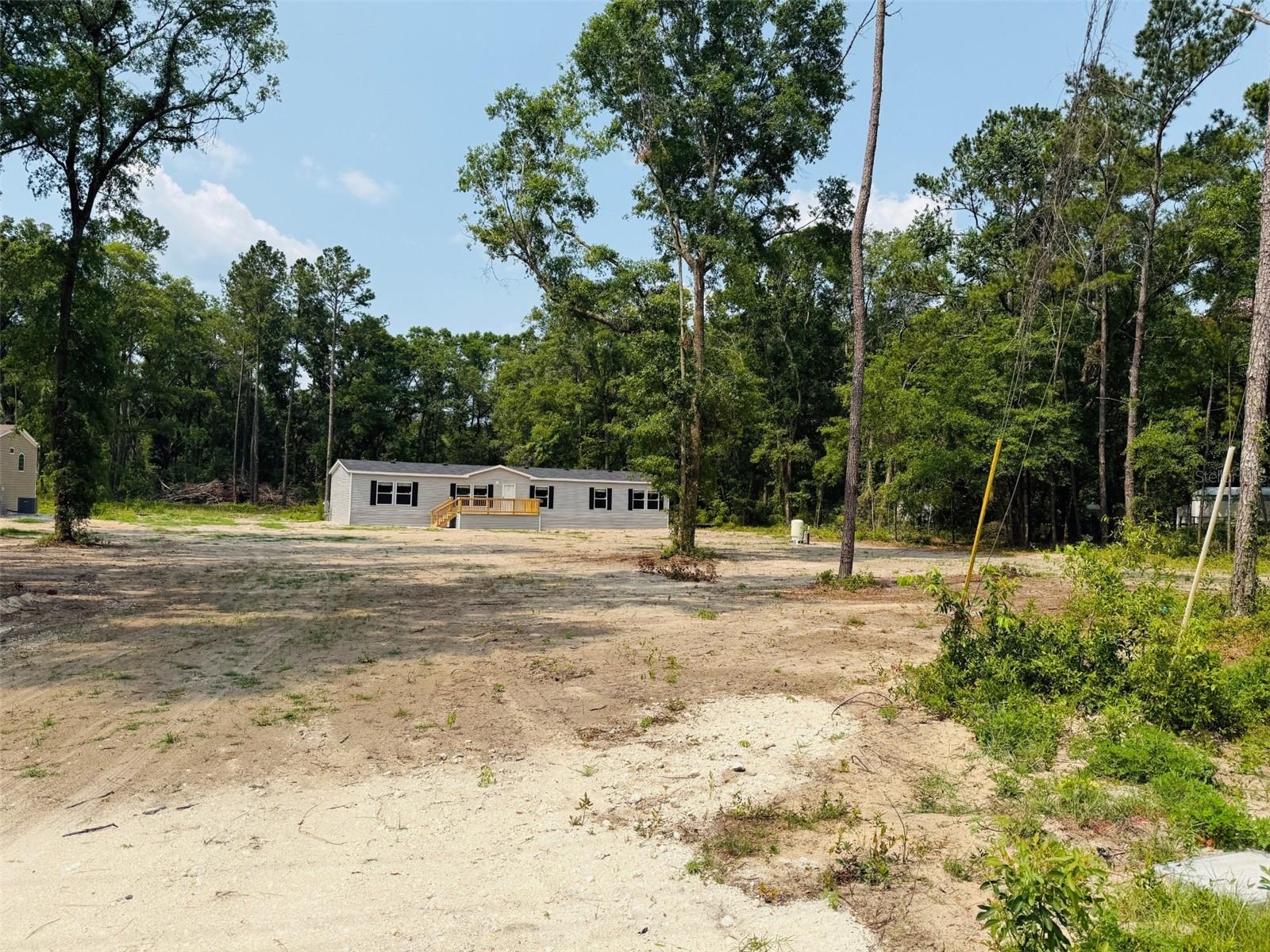 Never Lived in (New) 2022 Ironman Model on over an Acre! This 4Bed 2Bath( 2254 Sqft) features an open spacious floor plan with an Island kitchen. This HOME features a LRG Living room and Activity room* the 4 Bedrooms are very spacious along with His/her sinks* a Garden Tub and Separate Walk n Shower and Closet. This Home is on a paved road miles from Lake City and I 75.