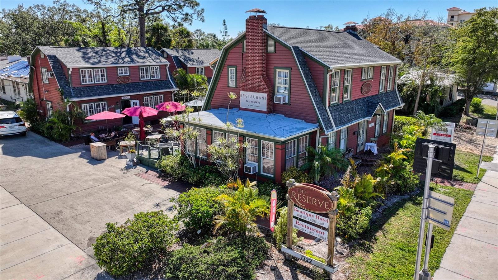 Discover a rarely available gem located at the gateway to downtown Sarasota. The historic Reserve Retreat is positioned with prime visibility in the vibrant downtown arts district. Set on a 0.26-acre lot with frontage along North Tamiami Trail/US41 as well as along 14th Street, this property is Urban Mixed Use NT (North Trail) and offers exceptional potential for a live-work situation or a host of other opportunities with its unique blend of 3 freestanding Mixed-Use buildings. Current income streams include 6 beautifully appointed en-suite hotel rooms (3 with kitchens) a lively café, and a restaurant tenant, all centered around a charming al fresco courtyard, and the property comes with two 2COP Beverage licenses.
Building One is 2,080 sq. ft. with a tenant-occupied ground floor (including kitchen and half bath) and 2 upstairs rooms with private baths; Building Two has 1,240 sq. ft. featuring a ground-floor café and half bath, plus 2 additional upstairs rooms with baths; and Building Three is 960 sq. ft. with 2 en-suite rooms and an attached laundry area. All new roofs!
The Reserve Retreat is minutes from stunning beaches, theaters, museums, galleries, and more, and is only 3 miles from the Sarasota/Bradenton International Airport. This is an exciting opportunity for those seeking a beautiful property with endless possibilities.