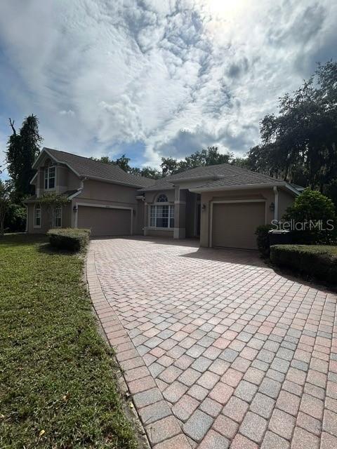This well maintained 4 bedroom 3 bath luxury home is ready for you. You will find plenty of entertaining room in this 2800+SQFT home with open and split floor plan, living, dining and family rooms, kitchen with granite counters, island and breakfast nook, bonus room over garage-would make a great theater room or 5th bedroom, spacious master suite offers an oversized walk-in custom closet and the master bath has dual vanities, glass shower and marvelous corner garden tub. Outside, you will find an inviting covered lanai that overlooks the fenced back yard, paver driveway and what every one dreams of-3 car garage! This home is located on a cul-de-sac in a gated community with plenty of amenities-community pool/spa, playground, and private clubhouse and located next door to nature trails. Just minutes from local shopping, dining, I-4 and 417 makes this a truly special home to live in. call us today to see this gem.