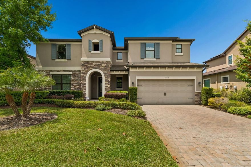 Welcome to the highly sought-after Palazzo floor plan by M/I Homes, one of the community’s most desirable and model-inspired floor plans, perfectly positioned in the award-winning community of Starkey Ranch. This stunning 4-bedroom, 4-bathroom home, includes a loft, downstairs office, and a 3-car tandem garage that showcases luxury, functionality, privacy, and breathtaking lakefront sunset views. From the moment you enter, you are greeted by soaring two-story ceilings, an open wood staircase with beautiful banisters, and an abundance of natural light that highlights the expansive open-concept layout. The impressive living and dining room combination offers an exceptionally large space that can be used however you desire, creating endless flexibility for entertaining, gatherings, or additional living space. The downstairs living areas feature elegant wood-look tile flooring, custom trim work, crown molding throughout, wainscoting details, and designer finishes at every turn.The gourmet kitchen is truly the heart of the home, featuring stainless steel appliances, built-in ovens, natural gas cooking, reverse osmosis, an oversized exotic granite island with seating for four, a butler’s pantry, and a spacious walk-in pantry. The large eat-in dining area off the kitchen flows seamlessly into the family room, creating the perfect space for everyday living and entertaining while still offering a warm and inviting atmosphere. The first-floor office offers the perfect work-from-home setup, while the convenient downstairs pool bath with shower provides easy access to the outdoor living space. Retreat to the luxurious primary suite showcasing a coffered ceiling with crown molding, spacious walk-in closets, and a spa-inspired bath complete with a soaking tub and frameless glass shower. Upstairs, the loft area offers the perfect additional TV room, playroom, or flex space. One of the many reasons the Palazzo floor plan is so highly sought after is the exceptionally spacious secondary bedrooms, offering comfort and flexibility for family and guests alike. One secondary bedroom features its own private en-suite bathroom, while the remaining two bedrooms share a well-appointed bath with dual sinks, providing both functionality and privacy. Step outside to your private resort-style backyard oasis featuring a heated saltwater pool and spa, tranquil lake views, and incredible sunsets that create the perfect setting for entertaining or relaxing in total privacy. Additional upgrades include hurricane shutters, solar panels, epoxy garage flooring, brick paver driveway and stone accents. Located in one of Tampa Bay’s most desirable master-planned communities, Starkey Ranch offers resort-style amenities including community pools, playgrounds, dog parks, a K-8 magnet school, community center, gardens, kayaks on Cunningham Lake, over 20 miles of walking and biking trails, and year-round community events. This is Florida living at its finest.