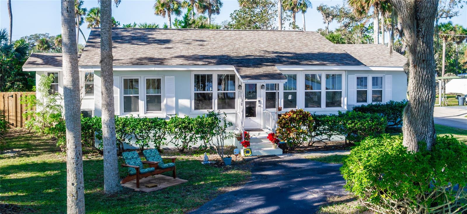 Location, location, location! Nestled on a stunning corner lot with serene Intracoastal views from every room, this exceptional riverfront retreat offers a wildlife sanctuary setting and riparian rights. Enjoy breathtaking views of the Halifax River and embrace the lifestyle you’ve been dreaming of in this 3-bedroom, 2-bath home. The versatile bonus/flex room is perfect for a home office, art studio, gym, or additional living space. A climate-controlled sunroom seamlessly blends indoor and outdoor living. From the moment you step inside you’ll be captivated by the warmth of hardwood floors throughout. The remodeled, easy-to-maintain kitchen boasts granite countertops, ample storage, and modern appliances. The primary suite is a peaceful refuge, complete with a fully remodeled ensuite (2024) with walk-in shower and double vanities. With over $250,000 in updates since 2016, you can move in with peace of mind including new roof (2019), new windows (2016), new HVAC system (2021), and tankless water heater (2019). A private dock, constructed in 2020 using composite decking, invites you to experience the very best of waterfront living. A separate IN-LAW SUITE (remodeled 2016-2017) with its own driveway, entrance, kitchen, and laundry facility, is perfect for guests, multigenerational living, or consistent rental income. Together, the main home and in-law suite provide approximately 1,985 square feet of climate-controlled living space. Walk, bike, or take a short drive to soft sandy beaches, shopping, and restaurants. This home is a true haven where history, nature, and elegance intertwine. Don’t miss the opportunity to make this peaceful waterfront oasis yours. Schedule your private showing today!
