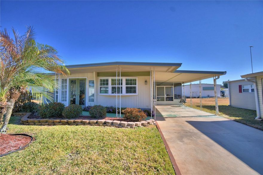 Welcome to Ariana Shores, where comfort meets a vibrant, active community lifestyle. This beautifully maintained 2-bedroom, 2-bath home features a desirable split-bedroom layout and a spacious living room that flows seamlessly into the dining area—perfect for everyday living and entertaining. The stunning Florida room, surrounded by windows, fills the home with natural light and provides the ideal space to relax and enjoy the Florida sunshine. Residents love the lively social atmosphere along with private access to Lake Arietta, including a boat ramp, fishing dock, and boat slips for endless enjoyment on the water.  Ariana Shores is a Co-Op Community, and the $30,000 Co-Op Share is included in the list price. Schedule your showing today and discover the lifestyle waiting for you at Ariana Shores.