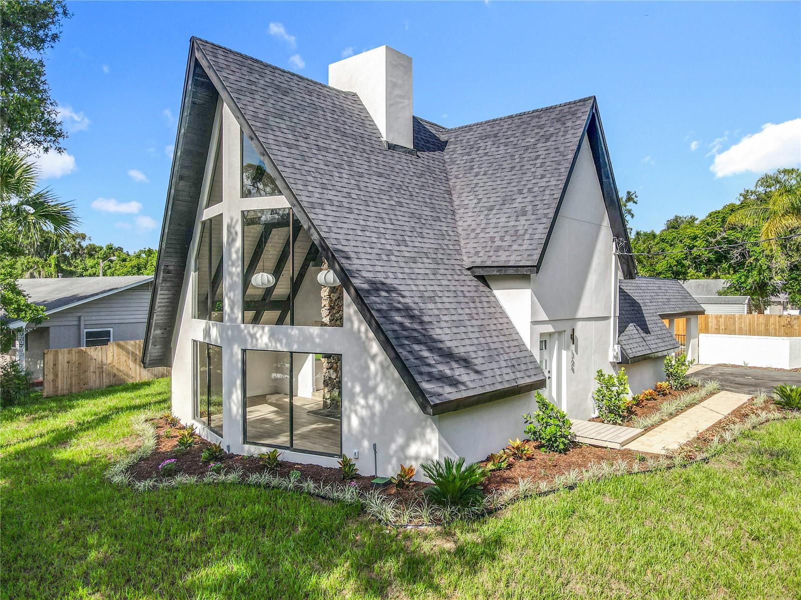 Welcome to this beautifully reimagined home located just minutes from the heart of historic downtown DeLand. Every inch of this property has been thoughtfully updated with premium finishes and modern design, offering the perfect blend of charm, style, and function.
Step inside to a light-filled living space featuring a striking masonry fireplace, the true focal point of the room, framed by large picture windows that invite natural light and views of the lush, newly landscaped yard. The chef’s kitchen boasts brand-new quartz countertops, cabinetry, and high-end fixtures — ideal for both entertaining and everyday living. The luxurious primary suite offers a spa-like retreat with a large walk-in shower, designer tilework, and upscale finishes that exude elegance. Outside, enjoy your private in-ground pool, perfect for Florida living and year-round enjoyment. From top to bottom, this home is completely new — from the roof to the floors and everything in between. Don't miss this rare opportunity to own a turn-key pool home near downtown DeLand with every upgrade imaginable!