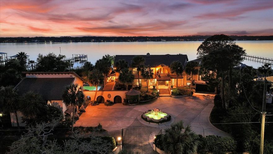 Welcome to one of the most magnificent Intracoastal estates in all of Ormond Beach. Perfectly positioned at 1010 John Anderson Drive, this Mediterranean-inspired compound offers nearly 9,000 square feet of living space, 156 feet of direct intracoastal frontage, and sits on a lush, gated 0.82-acre estate. Located just minutes from the beach, boutique shops, local dining, and the vibrant arts district, this address blends privacy, prestige, and coastal convenience.

Behind dual private gates, the estate unfolds across a 3-bedroom, 4.5-bath main residence and a beautifully designed 2-bedroom, 2-bath guest house with a full kitchen—ideal for multigenerational living, long-term guests, or a private retreat. A grand circular drive, framed by mature palms and anchored by a dramatic fountain, welcomes you to a home defined by craftsmanship, architectural drama, and refined living

Inside the main residence, timeless design and intricate detail shine. Hand-carved doors, ornate pillars, and rich woodwork throughout lend a sense of heritage and craftsmanship rarely seen in modern construction. Soaring ceilings and expansive living areas are perfectly complemented by walls of glass that frame stunning Intracoastal views and bathe the home in natural light.

At the heart of the estate is a Mediterranean-style courtyard with a resort-style pool, surrounded by arched breezeways, covered terraces, and lush landscaping. This central oasis connects the living spaces and creates a seamless indoor-outdoor flow—perfect for entertaining or simply enjoying the gentle rhythm of waterfront life.

Expansive and inviting, the primary suite blends comfort and romance with a wood-burning fireplace and a sweeping private balcony that frames panoramic Intracoastal views.

The fully-equipped guest house features its own entrance, two bedrooms, two baths, a full kitchen, generous living area, and patio access—providing maximum flexibility for guests, caretakers, or rental possibilities.

Additional features include a 5-car garage setup (3-car + 2-car), motorcourt parking for over 10 vehicles, and a private dock with boat lift—offering deep-water access for those who live for life on the water.

Offered FULLY FURNISHED if desired, the home is adorned with museum-worthy antique furnishings, artifacts, and curated pieces sourced from around the world. Every room tells a story—elegantly bridging the gap between global sophistication and coastal comfort.

The seller is also open to financing part of the purchase, offering a unique opportunity for prospective buyers to make this one-of-a-kind estate their own with tailored financial terms.

1010 John Anderson Drive is not just a home; it’s an estate designed for legacy living—offering the perfect blend of architectural grandeur, resort-style amenities, and a lifestyle that feels like a permanent vacation. Opportunities like this are rare, even on one of Florida’s most prestigious streets.
