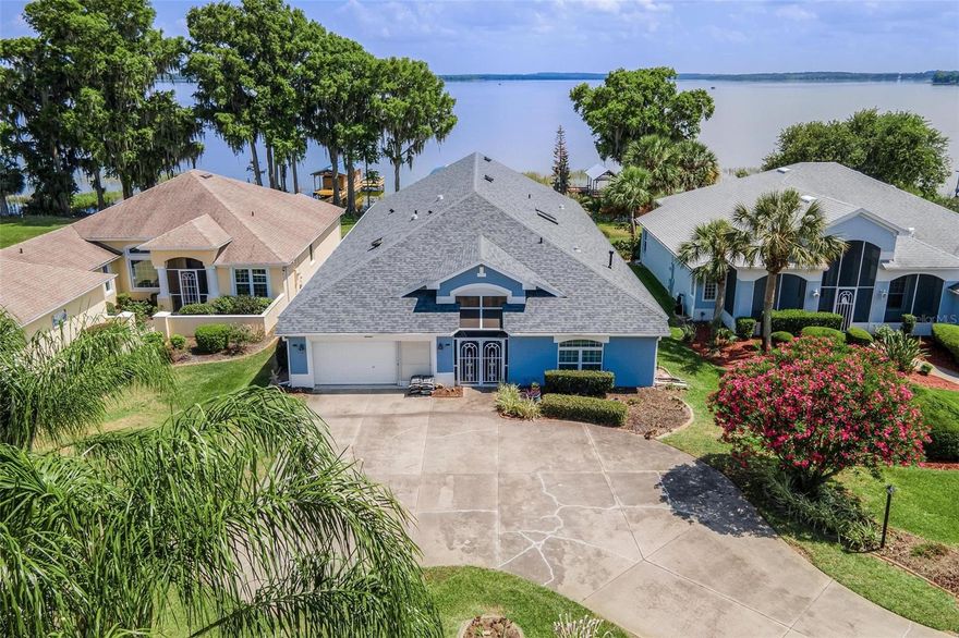 Experience the ultimate Florida lifestyle with this exceptional WATERFRONT HOME on the renowned Lake Harris CHAIN OF LAKES. Offering over 3,300 sq feet of living space, this spacious residence features four bedrooms, three baths and breathtaking views of LITTLE LAKE HARRIS. RECENT UPDATES INCLUDE A NEW ROOF IN 2024, NEW HVAC IN 2022, AND NEW INSTANT HOT WATER HEATER for added peace of mind. The expansive 33' x 12' FLORIDA ROOM PROVIDES THE PERFECT SETTING TO RELAX AND ENJOY PICTURESQUE WATERFRONT AND SUNSETS YEAR ROUND.  Located in the highly sought after Royal Harbor gated community, residents enjoy resort-style amenities. including a waterfront dock and fishing pier, RV and boat storage, the Lighthouse Recreation Center, scenic nature trails and bike pathS, tennis courts, pickleball, bocce ball, and a heated lakeside POOL AND SPA with screened enclosure.  This vibrant and active community offers the perfect blend of relaxation, and waterfront living--TRULY THE BEST YEARS OF YOUR LIFE AWAIT. COME AND LIVE THE FLORIDA LIFESTYLE.
