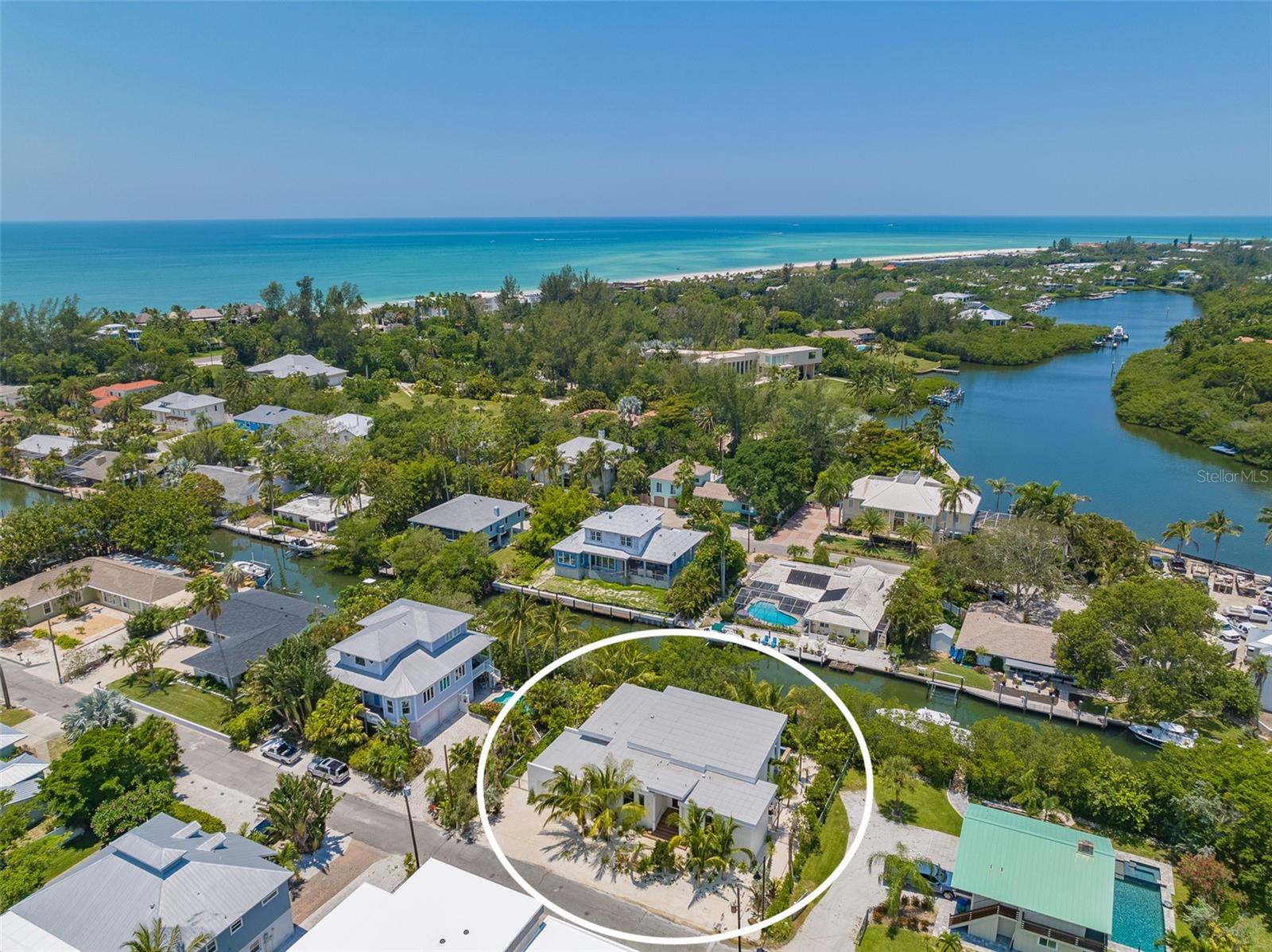 Offered fully furnished, this stunning, brand new custom estate home is nestled on one of the last remaining canal lots on the exclusive north end of Longboat Key. Designed by architect Bob Rokop and built by Mason Martin builders, this project is the perfect combination of artistry and craftmanship. This supremely private island retreat sits on a lushly landscaped lot with 100 ft of waterfront. Take your bike or paddleboard to nearby restaurants or walk to one of the world-renowned beaches of the Gulf coast. The floorplan allows for 3 ½ bathrooms and 3 spacious en suite bedrooms sharing no common walls, allowing for ultimate privacy within the home. Single level living allows for soaring sloped ceilings, reaching interior heights of 15 ft and the vaulted roofline extends to the outdoors, providing shaded space for entertaining. Outdoor living is highlighted by a 35 ft long lap pool and an expansive terrace for sunbathing and al fresco dining. The home’s gourmet kitchen includes custom solid wood box cabinet construction, quartz countertops, and offers the highest quality appliances from Wolf and Sub Zero. Kitchen and bathrooms include top of the line Waterworks fixtures. The master bathroom is complete with a floating double vanity, soaking tub and floor to ceiling natural stone wall tiles. Designed in perfect harmony with its surroundings, the main living area contains over 40 ft of glass sliders that are 10 ft tall with clerestory glass above, merging exterior and interior spaces seamlessly and bringing natural light and landscape into the home. Timeless design elements of the residence revolve around the fundamentals of gulf coast mid-century architecture, including an open plan design, simple overall volumes and premier construction methods. This breathtaking property is minutes away from everything the island has to offer, yet a world apart.