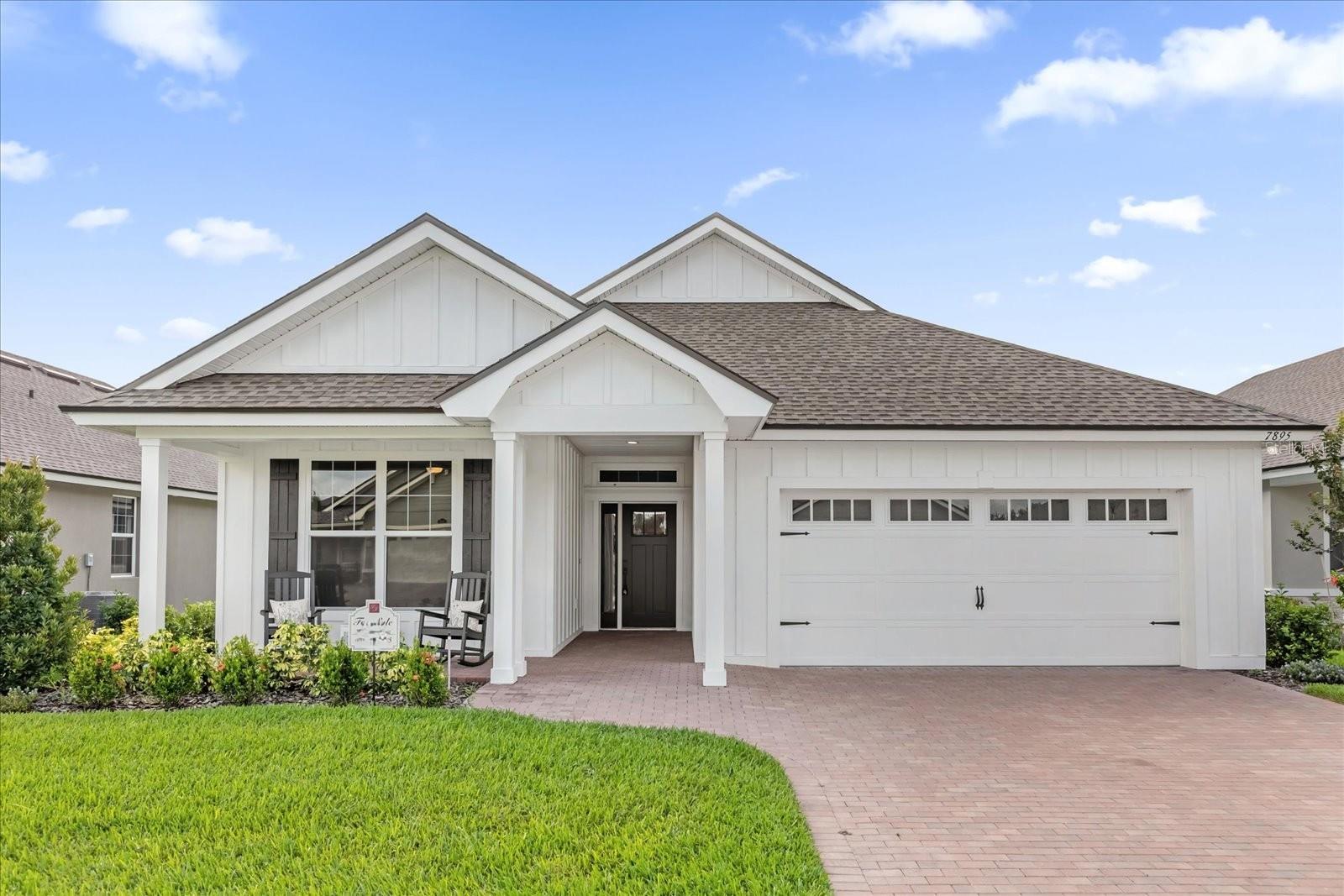 Live the Good Life in this EXCLUSIVE 55+ GATED COMMUNITY of LAKE JAMES! Get ready to fall in love with this *NEW GIBSON IV* home with welcoming CRAFTSMAN STYLE inside and out. This ERNIE WHITE built home in the sought after 55+ gated community of LAKE JAMES in Lakeland has everything you could want in a NEW home. This 3 Bed, 2 Bath welcomes you with a BRICK PAVER DRIVEWAY and a covered FRONT PORCH to relax and meet your neighbors. Step through the front door to an open concept layout that is ideal for gatherings. The GREAT ROOM features WOOD PLANK tile, VAULTED ceilings, and includes generous space for furniture. The KITCHEN features WARM WOOD CABINETRY with complimenting QUARTZ countertops, and WHITE SUBWAY TILE backsplash. This space is made complete with CLOSET PANTRY, over-sized ISLAND with sink and dishwasher prep. STAINLESS STEEL appliances and plenty of cabinet and countertop space. The DINING space is located just off the kitchen and opens to the GREAT ROOM for ease of entertaining. A SPLIT FLOOR PLAN gives everyone their own space. The spacious PRIMARY suite easily fits a king-size bed and features an OVER-SIZED walk-in closet, WARM WOOD double vanities, QUARTZ countertops, and a luxurious walk-in shower. The TWO additional bedrooms are great for guests or flex space for office and hobbies. The guest bath also features BEAUTIFUL wood cabinets with QUARTZ countertops. Step out back to your own private oasis with a large SCREENED-IN, paver patio perfect for relaxing, reading, or grilling up something delicious on the extra paved BBQ area. All of this is located within this PREMIER community in Lakeland, mere miles from Interstate 4. Enjoy RESORT STYLE amenities including a clubhouse, heated community pool, fitness center, and scenic walking trails. A MONTHLY FEE covers essentials like LAWN MAINTENANCE, CABLE, & INTERNET (with NO CDD FEE), ensuring a carefree lifestyle. DISCOVER why so many people fall in love and are PROUD to call LAKE JAMES home. Make your appointment to see TODAY!