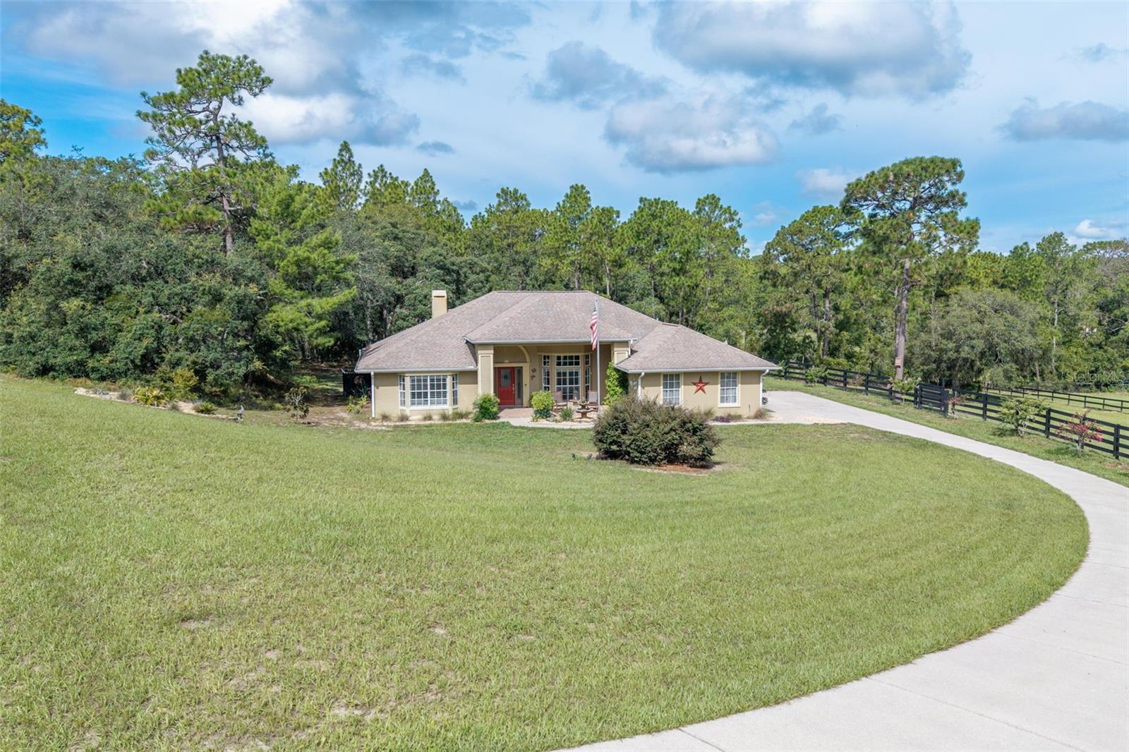 Beautiful 3-Bedroom, 2-Bath Pool Home on 2.91 Acres in Pine Ridge, Florida with New Barn Welcome to your private retreat in the desirable Pine Ridge community! This charming 3-bedroom, 2-bath home sits on a spacious 2.91-acre property, fenced and crossed fenced, offering privacy, room to roam, and the perfect blend of comfort and country living. Your horses will love it! It also has 2082 living square feet and 2984 total square feet. Step inside to a well-maintained interior featuring an open-concept living area, a bright kitchen with plenty of storage, and a split-bedroom floor plan for added privacy. The master suite includes an en-suite bathroom and a walk-in closet, while two additional bedrooms and a full bath provide space for family or guests. Enjoy year-round outdoor living with your own screened-in inground saltwater pool, with new pool equipment, and solar heat, ideal for entertaining or relaxing in the Florida sunshine. The fenced yard is great for pets, play, or gardening. A highlight of this property is the brand new 24’ x 44’ barn, perfect for storing equipment, vehicles, or setting up a workshop or hobby space. Turn it into four stalls or potential tack room, etc.. This would be perfect for horses too. The roof is a 2015 and the AC is 2022. So many details on this home, including plantation shutters throughout the home the beautiful gas fireplace with a live edge shelving, New landscaping, including drainage improvements, wood fence, gates, Newer appliances, crown molding, too many to list. Located in equestrian-friendly Pine Ridge, you'll have access to miles of horse trails, parks, and a peaceful, nature-rich setting, all just a short drive from shopping, dining, and Gulf Coast attractions.