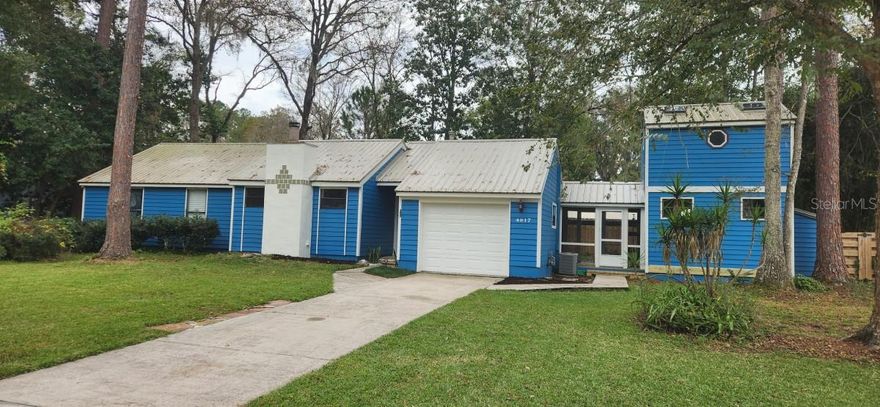 IDEAL FOR WORK FROM HOME! You must see this beautiful 3-bedroom, 2 bath home on a quiet cul-de-sac in a northwest Gainesville neighborhood.  This unique home has a two-story 12’x16’ attached outbuilding, not included in the listed square footage.  It adds 384 square feet, perfect for an office or 4th bedroom with loft.  It also has a new backyard deck and detached screened patio room for outside enjoyment without pests!  Updated features include new metal roof, new decking, new carpet, new tile in the dining room, new exterior and interior paint, and a privacy fence.  New AT&T fiber internet connectivity available! Working fireplace, skylights in bathrooms and outbuilding, and a one-car garage with large, decked attic storage area.  The kitchen features wood cabinet doors, gas stove, pantry, butcher block and stainless prep table and pot rack. School zone:  Glen Springs Elementary, Fort Clark Middle, and Buchholz High.