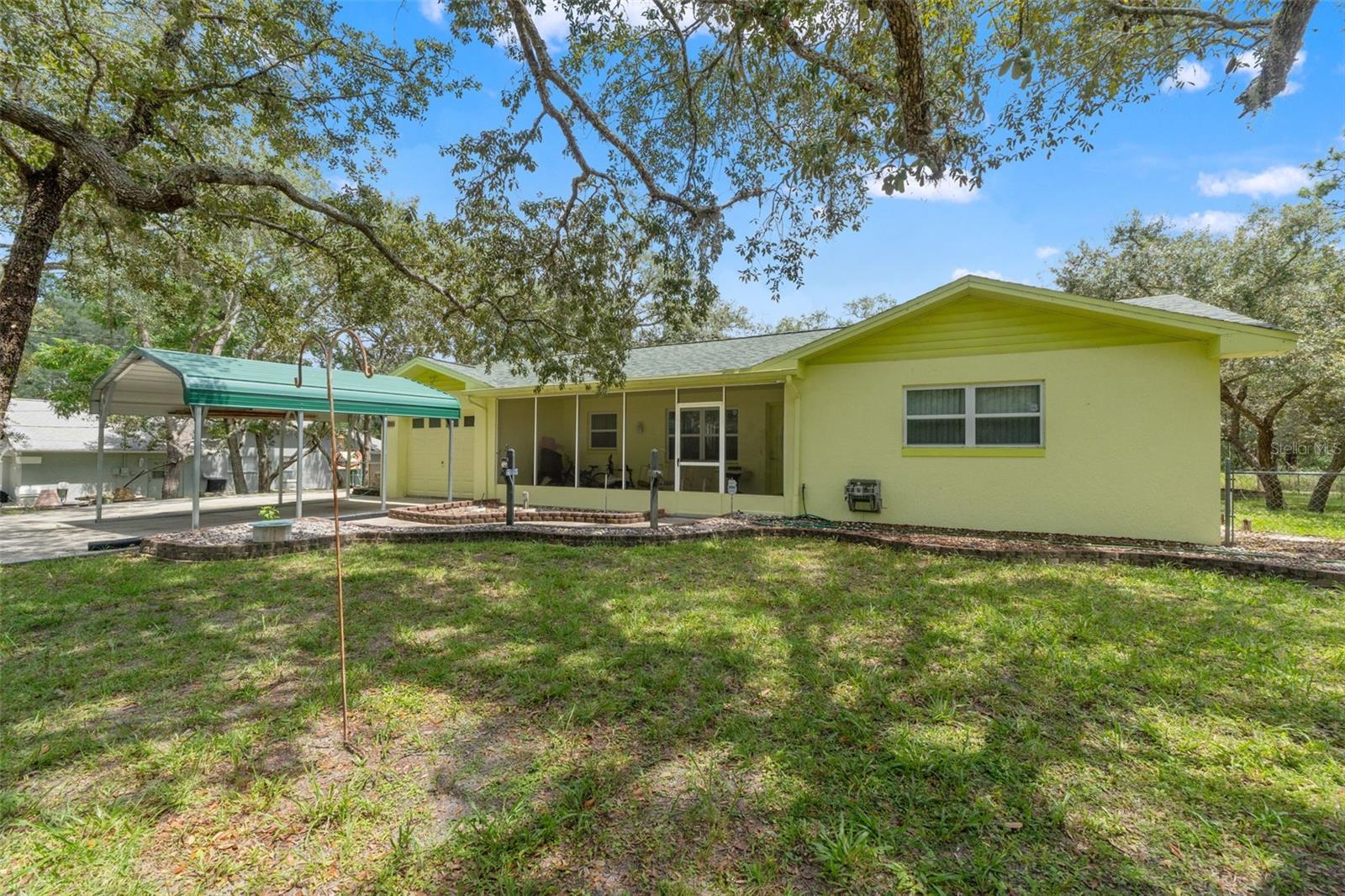 One or more photo(s) has been virtually staged. PRIVATE + PEACEFUL WEEKI WACHEE HOME ON OVER HALF ACRE + END OF DEAD-END ROAD • FULLY FENCED • NEW ROOF 2022 • BRAND-NEW AC 2025 AND 1-CAR GARAGE & CARPORT. Love privacy and space, without giving up convenience? This 2-bedroom Weeki Wachee home sits on over half an acre with a CHAIN-LINK FENCED YARD—quiet, tucked away, and ready for everyday living. You're just minutes to SR-50 for shopping, dining, and daily errands.
Inside, enjoy comfortable layout with a WOOD-BURNING FIREPLACE, SCREEN ENCLOSED FRONT PORCH and NEWER APPLIANCES. Big ticket items are handled: NEW ROOF (2022), BRAND-NEW AC (2025), and a NEWER HOT WATER HEATER. Parking is easy with a 1-CAR GARAGE plus a CARPORT for extra vehicles or toys. The large yard is a true highlight—room for pets, a garden, and weekend projects. Spend your free time outdoors: Weeki Wachee Springs is nearby for kayaking and manatee spotting, Hernando Beach offers Gulf sunsets and seafood, and Homosassa brings scalloping, fishing, and classic Florida charm. NO HOA, NO CDD AND NO FLOOD ZONE