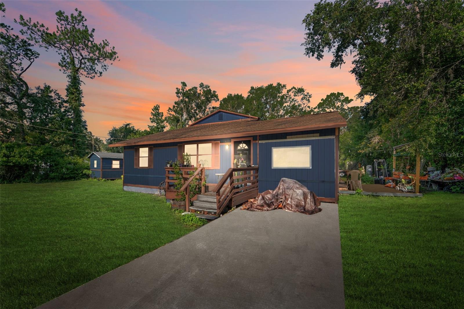 Welcome to this one-of-a-kind property in the heart of Lutz, offering two separate homes on a spacious lot. Perfect for multigenerational living, guests, or even rental income, this rare find features a charming 3-bedroom, 2.5-bathroom main home with 1,592 sq ft of heated living space, and a 2-bedroom, 2-bathroom second home with 1,382 sq ft of heated space. The main home boasts a spacious kitchen with a large island, perfect for entertaining friends and family, and a balcony off the master bedroom upstairs, providing a peaceful retreat with scenic views. Both homes will need some TLC but offer incredible potential. They each have their own mailboxes, electric meters, and septic systems, with shared well access. Recent upgrades include a new leach field, newer HVAC units (2020), and an updated well filtration system. The property also features detached structures for farm animals, 2 outbuildings for storage and a private setting with no rear neighbors! Last but not least, no HOA or CDD fees. Bring your RV's/Boats, plenty of space to store them. Located in a desirable area of Lutz, this property offers endless possibilities, whether you’re seeking a flexible living arrangement, an investment property, or a peaceful retreat. Don’t miss out on this rare opportunity – schedule a viewing today!