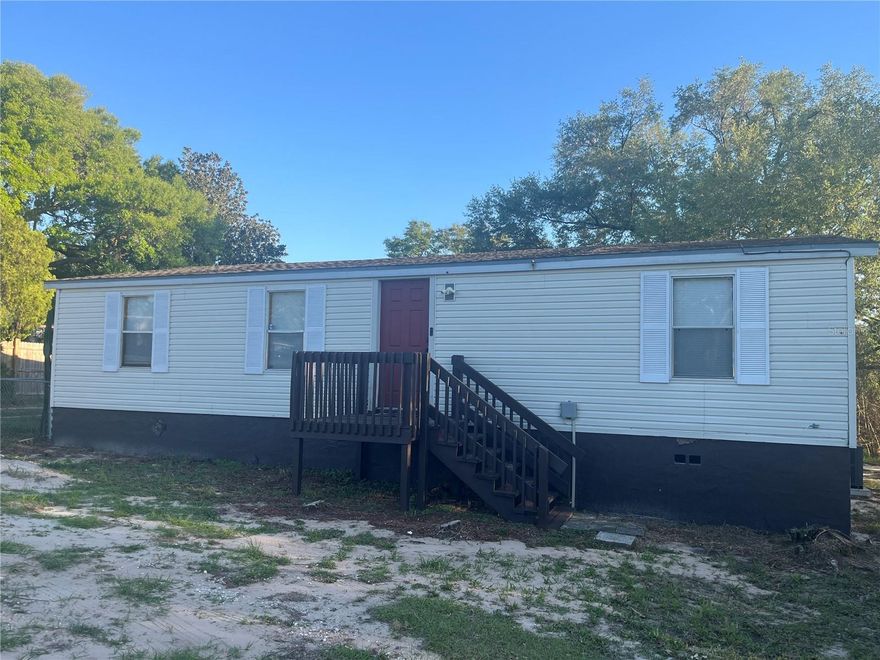 Discover the Potential in the heart of Lake Wales! This 3-bedroom, 2-bathroom double-wide manufactured home is situated on an oversized 0.34-acre lot , in the quiet Carlton Manor subdivision. Boasting 1,056 sq. ft. of living area, the home features a functional living room/dining room combo and a 3 spacious rooms. The exterior includes a screened porch, a utility closet , and a partially chain-link fenced yard, providing plenty of space for outdoor activities, gardening, or storage.
Located in a non-HOA area with public water , this property offers freedom and convenience. You are just minutes away from shopping  and the amenities of downtown Lake Wales. Whether you are looking for an affordable primary residence or a high Return on rental investment, this property is a must-see. Schedule your showing today!" Property sold ASIS.