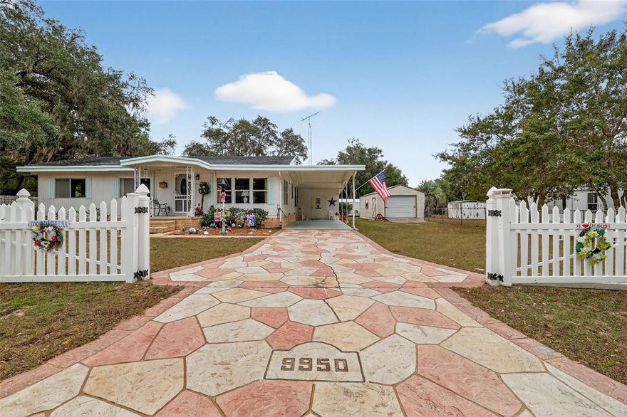 • NO HOA • FURNISHED • LARGE YARD • EXTRA STORAGE • LARGE SUNROOM • NEW WELL PUMP & BLADDER TANK • NEW APPLIANCES • Welcome to 9950 SE 169th Street - a rare opportunity to own a well-maintained, move-in-ready manufactured home with an oversized lot in the heart of Summerfield. This Skyline-built manufactured home offers lasting quality and craftsmanship that's hard to find today. With 2 bedrooms and 2 full bathrooms, this charming residence offers functional living spaces inside and out. The home opens into a cozy, carpeted living room that flows into the dining area and kitchen, where newer stainless steel appliances add a modern touch.

The layout is thoughtfully designed, with the spacious primary bedroom featuring an en-suite bath and walk-in shower, while the guest bedroom includes a ceiling fan and a built-in closet with easy access to a second full bath. Step into the large, enclosed sunroom, an ideal flex space, and out onto the expansive 12x20-foot patio, perfect for entertaining or relaxing under the Florida sky.

Outside, the fully fenced 0.35-acre yard includes a 14x30-foot detached garage, a 10x20-foot shed, and another 12x16-foot storage shed, which includes the washer and dryer. There's ample space for a garden, workshop, animals, or even a home business. The stamped concrete driveway, carport, and mature trees add both function and charm. Located minutes from Hwy 441, 301, The Villages, shopping, dining, and local schools. This is a must-see with endless potential.