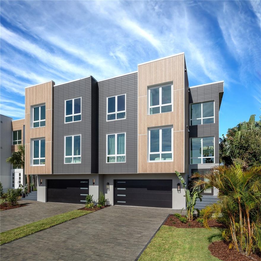 Incredible opportunity to move right in to a fully furnished and custom-designed waterfront
luxury home featured on HGTV’s hit show Rock the Block.  There are 3 other completed models available in this community.  Award-winning designers created a 5-star resort vibe inside and out. The 3,638 SF home features 4 bedrooms, 5 bathrooms, a 4-
car garage, and an elevator. The modern kitchen, butler’s pantry, and bars feature custom 
flat panel cabinetry, high-end Jenn-Aire appliances, gorgeous marble surfaces, and a unique
built-in dining area. The primary suite has floor-to-ceiling windows, a private balcony, a
fireplace, and a spa-like bathroom with dual floating vanities, a soaking tub, and a
luxurious shower with high-end features. There are three floors of outdoor living spaces,
including a huge 12’ X 33’ balcony on the main floor with sliding glass doors spanning 24’ that
create a true indoor/ outdoor living room. Take the exterior spiral stairs down to the private pool
with fountains, custom decking, a fire pit, and 700 SF of covered patio space with a built-in bar
area and grill. The building is a duplex and each unit lives like a single-family home with its own
fenced yard, private resort-style pool, and boat slip. This location is a boater’s paradise, where
you can be out in the Gulf via John’s Pass in 5 minutes. Come enjoy the best of beach living in
a brand-new home built to last with today’s codes and standards.