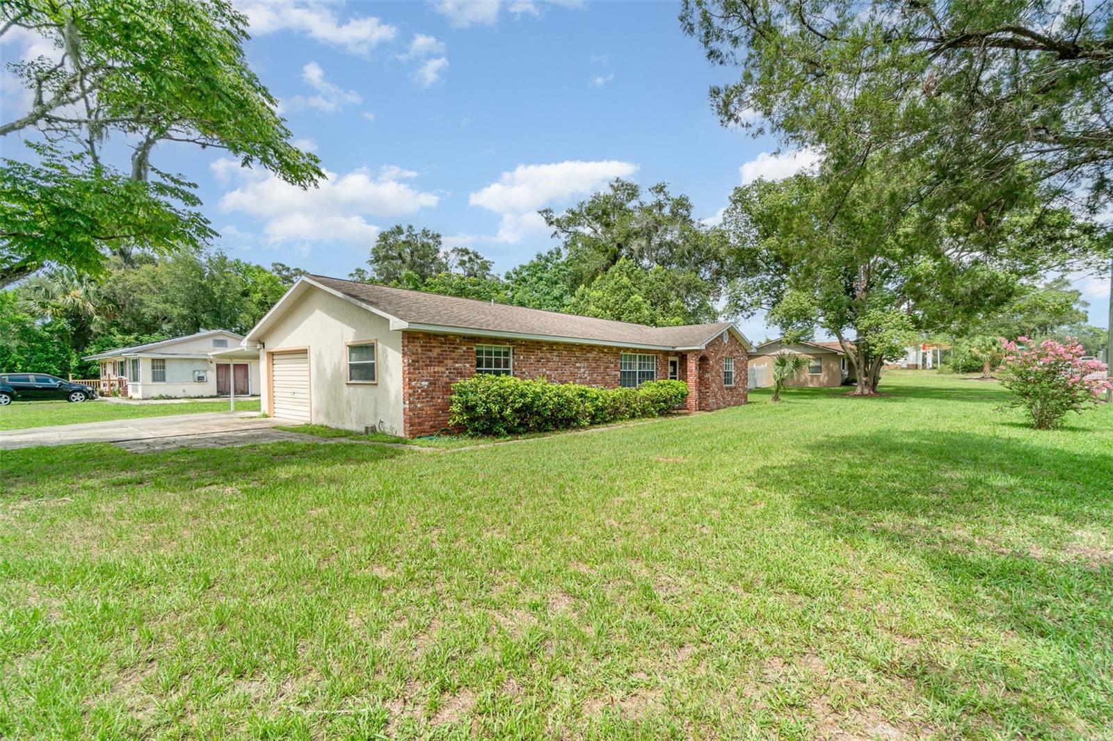 Charming 3-bedroom, 2-bathroom home on a spacious corner lot in the heart of Orange City! This well-kept property features a bright and open floor plan, a cozy living area, and two generously sized bedrooms. Enjoy the convenience of both a garage and a covered carport—perfect for extra parking or storage. The large lot offers plenty of outdoor space for entertaining, gardening, or relaxing under the Florida sun. Located close to local shops, restaurants, parks, and Blue Spring State Park.