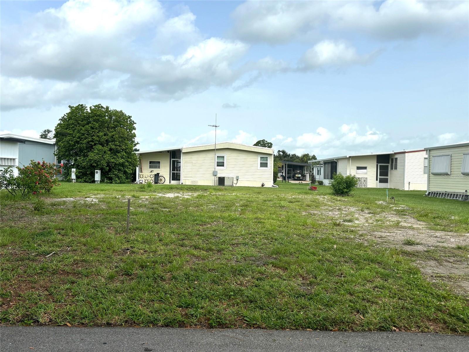 Vacant lot with a view of our beautiful Memorial Garden and just down the street from Lake Del Hacienda. La Casa, a vibrant 55+ community, offers the ultimate Florida lifestyle. We have 974 homes nestled among a variety of native trees with spacious common grounds surrounding our eight lakes. Located between Sarasota and Fort Myers, this is a boater's dream with access to the Gulf of Mexico. It is convenient for shopping, sightseeing, golfing, fishing, and boating, as well as all the culture and elegance the Southwest Florida area is noted for. La Casa may have the best pools in the area. Our crown jewel is an extremely large, 40 X 60-foot swimming pool that is kept at a perfect 87 degrees. Our smaller 20 x 40 pool is quietly nestled between the clubhouse and the Activity Building. Both pools have adjacent hot tubs which are ideal for soaking muscles that are tired from golfing or tennis. Wireless Internet (Wi-Fi) is available at the Clubhouse, Activity Building, and Recreation Hall area where these pools & spas are located, so you can catch some rays while you catch up on your email! Sound enticing? Come for a visit to this self-contained oasis and see for yourself why La Casa is the ultimate destination for both snowbirds and year-round residents!