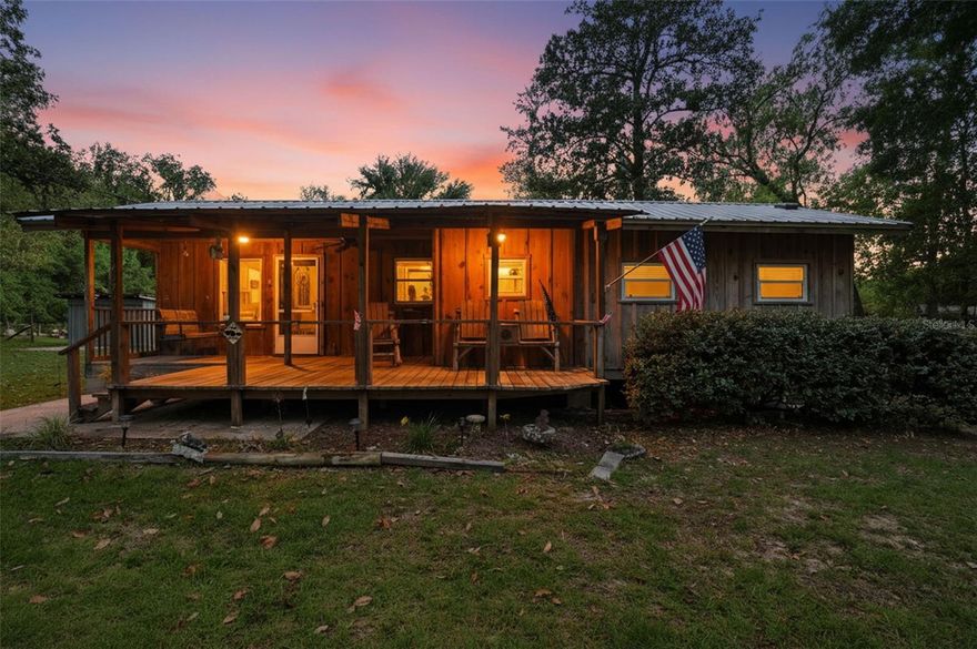 Meticulously maintained 1-bedroom, 1.5-bath home situated on 0.68 acres of cleared and fenced property, offering privacy along a quiet private road. Beautiful cabin was built inside and out from local Pecky Cypress and Cedar wood. This property features a spacious front porch and an expansive rear porch complete with an outdoor shower—ideal for enjoying the peaceful, natural surroundings.

The property is well-equipped with a 12x12 storage shed, a 32x24 detached garage, and a 16x40 pole barn. The pole barn provides covered storage for the included 2000 Salem 27BH camper, adding versatility and value. Recent updates include a 2019 metal roof and a new water softener.

Ideal for those seeking space, functionality, and a well-maintained property with room for hobbies, storage, or recreational use.

Located in the Ocala National Forest, this property offers a true outdoor lifestyle with convenient access to hunting, hiking, horseback riding, and ATV trails. Enjoy nearby natural attractions such as Salt Springs Recreation Area, Juniper Springs Recreation Area, and minutes from the beautiful untouched Ocklawaha River—perfect for boating, kayaking, and fishing.

Additional nearby destinations include Rodman Dam and Hog Waller Mud Bog & ATV Park, known for its over 1000+ acres of expansive riding trails, mudding, monster truck events, and weekend camping.

Conveniently located within a short drive to Ocala for shopping, dining, and everyday amenities, and approximately one hour from Daytona Beach.