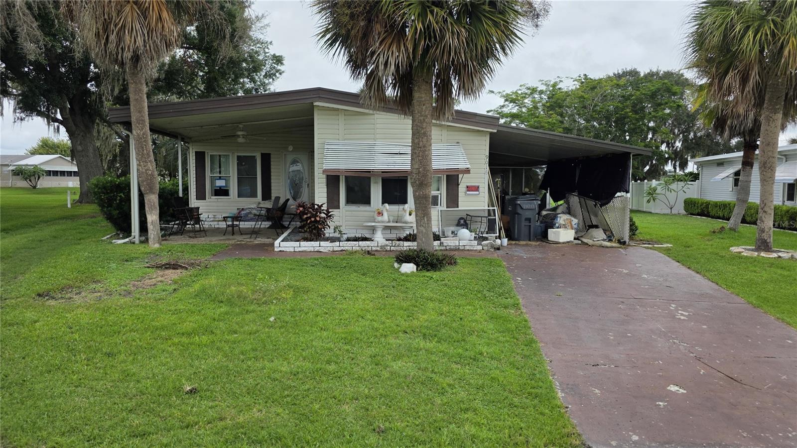 Investor alert! You own the land with NO HOA! Huge potential on nearly a full acre in Polk City, backing to a canal with stunning water and sunset views. This 2-bedroom, 2-bath home needs some love and repairs, but with vision and effort, it could become an absolute gem. Spacious living areas, huge wrap-around lanai, and a workshop give you endless possibilities. One of the largest lots in the neighborhood, mature trees, and serene surroundings make this a rare find. Don’t miss your chance to unlock the value and create something truly special!