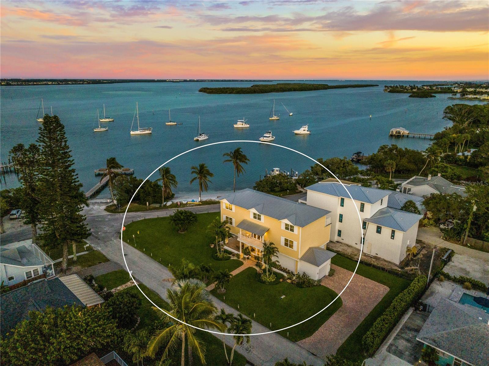 Welcome to Longboat Key, Florida, where luxury and relaxation meet! This beautiful barrier island is surrounded by pristine white sandy beaches and crystal-clear waters, providing a picturesque backdrop for the ultimate Florida experience. This stunning property is located in the charming community of Long Beach Village, known for its laid-back lifestyle. The Village, as it's commonly referred to, sets the scene for your idyllic vacation lifestyle. Take full advantage of the private beach overlooking Sarasota Bay, just a few steps from your front door, or take a quick stroll to the beautiful beaches of the Gulf of Mexico. If you want to spend the day kayaking, fishing, or boating, utilize the neighborhood boat ramp, several community fishing piers, and kayak launches. The Village is also known for its outstanding restaurants, including Shore, Mar Vista, and Whitneys Roadside, all within walking distance. This elegant and charming home features breathtaking bay views from almost every vantage point in the home, an open floor plan, and an in-home elevator, making it the perfect blend of style and convenience. This home was completely rebuilt and redesigned from the first floor up in 2016, including impact windows, electrical, plumbing, and the addition of the top floor. Now boasting over 3600 square feet of living space on multiple living levels, this home offers ample room for relaxation and entertainment. You will be impressed by the meticulous attention to detail and high-end finishes throughout the home. The outside decks and covered patio offer incredible water views, creating the ideal setting for relaxing or gathering with friends and family. Your dream of the Florida lifestyle begins today!