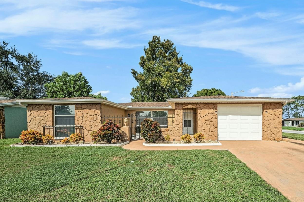 Welcome to this beautifully appointed 3-bedroom, 2-bath residence, perfectly situated on a
desirable corner lot. Designed with both style and function in mind, the home features an inviting
open-concept split floor plan that seamlessly blends everyday comfort with effortless
entertaining.
The heart of the home is the spacious kitchen, showcasing rich all-wood cabinetry, gleaming
granite countertops, a breakfast bar, and stainless-steel appliances—ideal for both casual meals
and culinary creativity. Both bathrooms are equally refined, each offering granite vanities for a
touch of modern elegance.
The open flow of the living and dining spaces leads effortlessly to an enclosed patio, providing a
versatile area for year-round enjoyment. A one-car garage adds convenience and practicality to
this thoughtfully designed home.