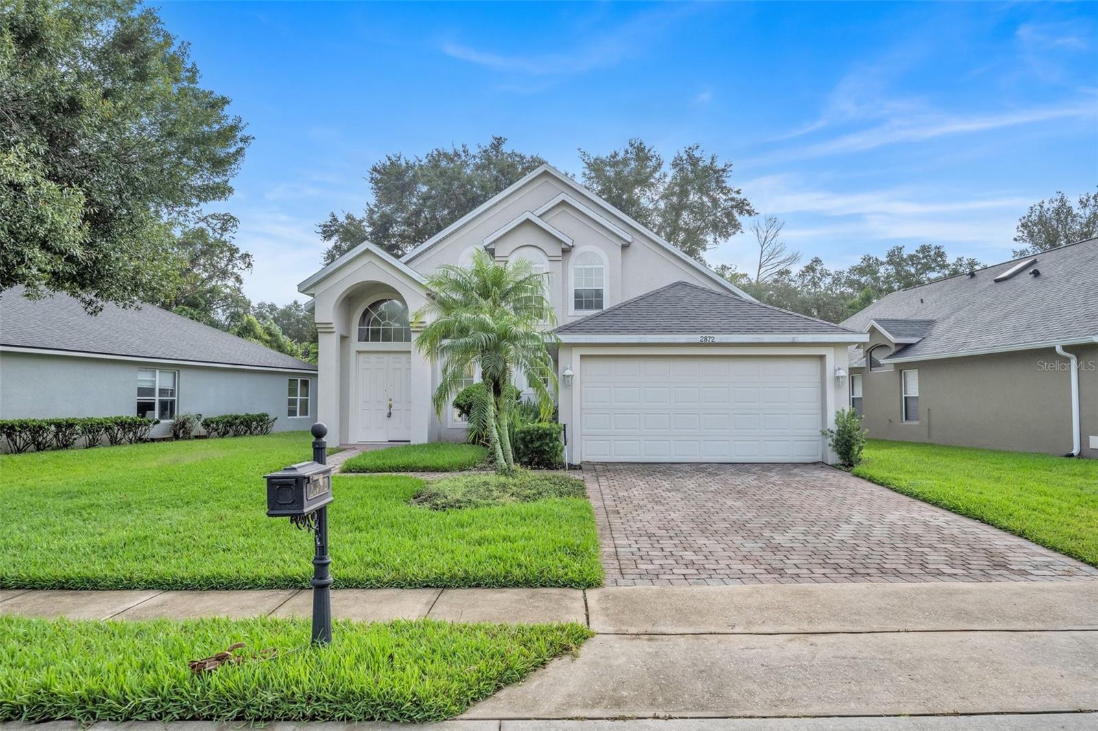 Welcome to your next home in the highly sought-after Sanctuary community of Oviedo. This beautifully maintained two-story residence offers 4 bedrooms, 2.5 bathrooms, and over 2,300 square feet of comfortable living space. Backing up to peaceful conservation land, this property offers privacy and scenic views that are perfect for relaxing evenings on the screened-in back patio. Inside, you'll find an open layout with high ceilings and great natural light. The main floor includes a spacious primary suite with a walk-in closet, dual vanities, soaking tub, and separate shower. The kitchen features Corian countertops, ample cabinetry with pull-out drawers, and all major appliances, flowing seamlessly into the living and dining areas.