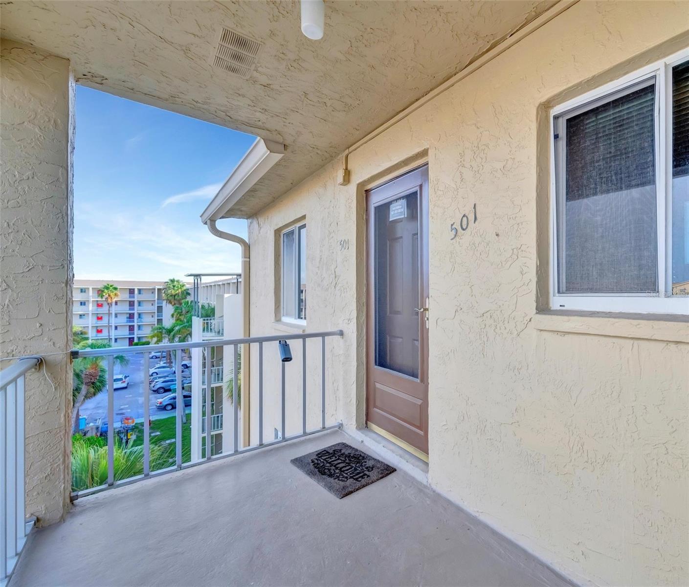 FRESHLY UPDATED! Drift into your own slice of coastal paradise with this unique condo in the vibrant 55+ community of Bayshore on the Lake. Move-in-ready gem, fully furnished with everything you need from furnishings to forks. The AC is recent (‘20), water heater is brand new (‘24), and there’s a washer/dryer tucked right in the unit. Recessed lighting, ceiling fans, and hardwired fire alarms ('21) add that extra touch of comfort and safety. With an elevator and your own parking spot you’ll have an easy zip to the beaches. The building’s roof is fresh too—no extra fees to worry about, no flood insurance needed plus a recent structural engineering report on file for total peace of mind.
Step inside and feel bright, open living spaces with engineered flooring throughout. The kitchen’s a coastal dream—high-end SS appliances, quartz countertops plus large pantry and under-cabinet lighting. Both bathrooms are decked out with walk-in showers, crisp new vanities. Frosted barn doors (fresh from Chicago) slide open in both living space and primary bedroom. You’ll find the nature preserve and trail views from the lanai—coastal living at its finest. Bayshore on the Lake is where coastal charm meets resort-style fun. Priced $30K under recent appraisal, the low HOA fees cover cable, internet, trash, amazing pool, a serene lake, kayak storage and a clubhouse with library and meeting spaces, perfect for swapping stories with neighbors.
This condo is ready to whisk you away, packed with coastal-cool upgrades and all the furniture you need to live your beachy best. It’s more than a home—it’s your coastal escape, where every day feels like a walk on the shore. You don’t want to miss this unique condo so schedule your appointment and feel the breeze…let your seaside story begin!