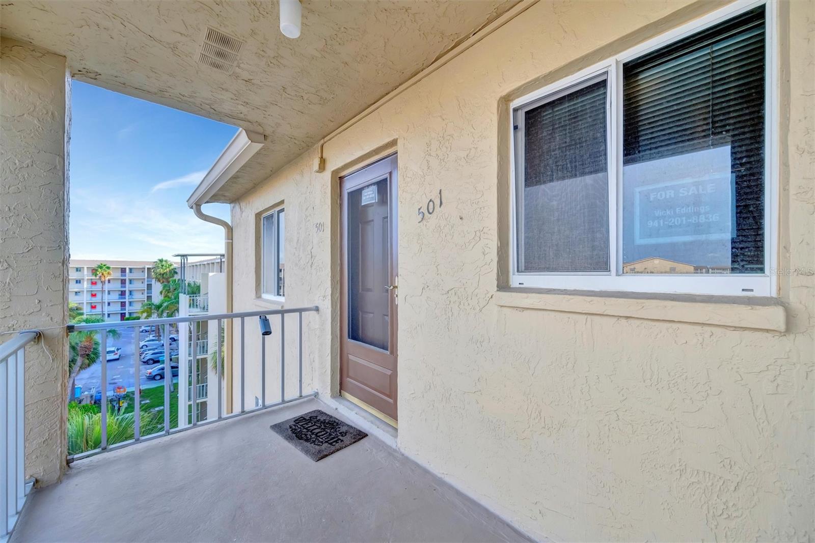 FRESHLY UPDATED! Drift into your own slice of coastal paradise with this unique condo in the vibrant 55+ community of Bayshore on the Lake. Move-in-ready gem, fully furnished with everything you need from furnishings to forks. The AC is recent (‘20), water heater is brand new (‘24), and there’s a washer/dryer tucked right in the unit. Recessed lighting, ceiling fans, and hardwired fire alarms ('21) add that extra touch of comfort and safety. With an elevator and your own parking spot you’ll have an easy zip to the beaches. The building’s roof is fresh too—no extra fees to worry about, no flood insurance needed plus a recent structural engineering report on file for total peace of mind.
Step inside and feel bright, open living spaces with engineered flooring throughout. The kitchen’s a coastal dream—high-end SS appliances, quartz countertops plus large pantry and under-cabinet lighting. Both bathrooms are decked out with walk-in showers, crisp new vanities. Frosted barn doors (fresh from Chicago) slide open in both living space and primary bedroom. You’ll find the nature preserve and trail views from the lanai—coastal living at its finest. Bayshore on the Lake is where coastal charm meets resort-style fun. Priced $30K under recent appraisal, the low HOA fees cover cable, internet, trash, amazing pool, a serene lake, kayak storage and a clubhouse with library and meeting spaces, perfect for swapping stories with neighbors.
This condo is ready to whisk you away, packed with coastal-cool upgrades and all the furniture you need to live your beachy best. It’s more than a home—it’s your coastal escape, where every day feels like a walk on the shore. You don’t want to miss this unique condo so schedule your appointment and feel the breeze…let your seaside story begin!
