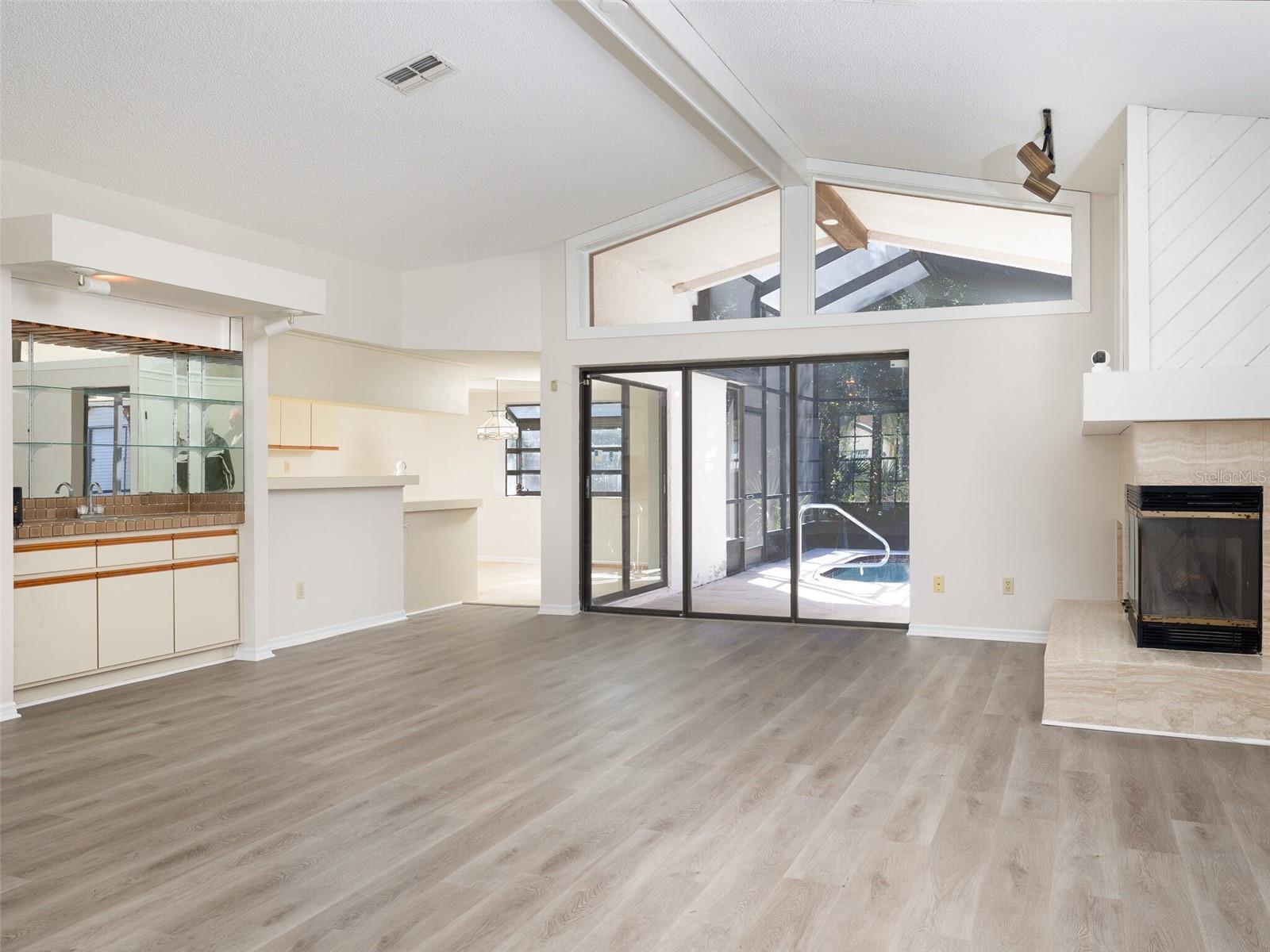 Welcome to 8260 Berkeley Manor in the desirable Berkeley Manor community! This 3-bedroom, 2.5-bath pool home offers over 1,800 sq ft of living space with an open-concept layout, soaring ceilings, and skylights that fill the home with natural light. Enjoy a spacious kitchen and living area with a cozy fireplace—ideal for entertaining. Updates include new LVP flooring, interior paint (2023), pool pump (2023), new skylights (2024), new pool cage screens (2023), and a brand-new A/C system (2024). Step outside to your private screened-in pool and enjoy the Florida lifestyle. With a 2-car garage and prime location, this home has endless potential!
