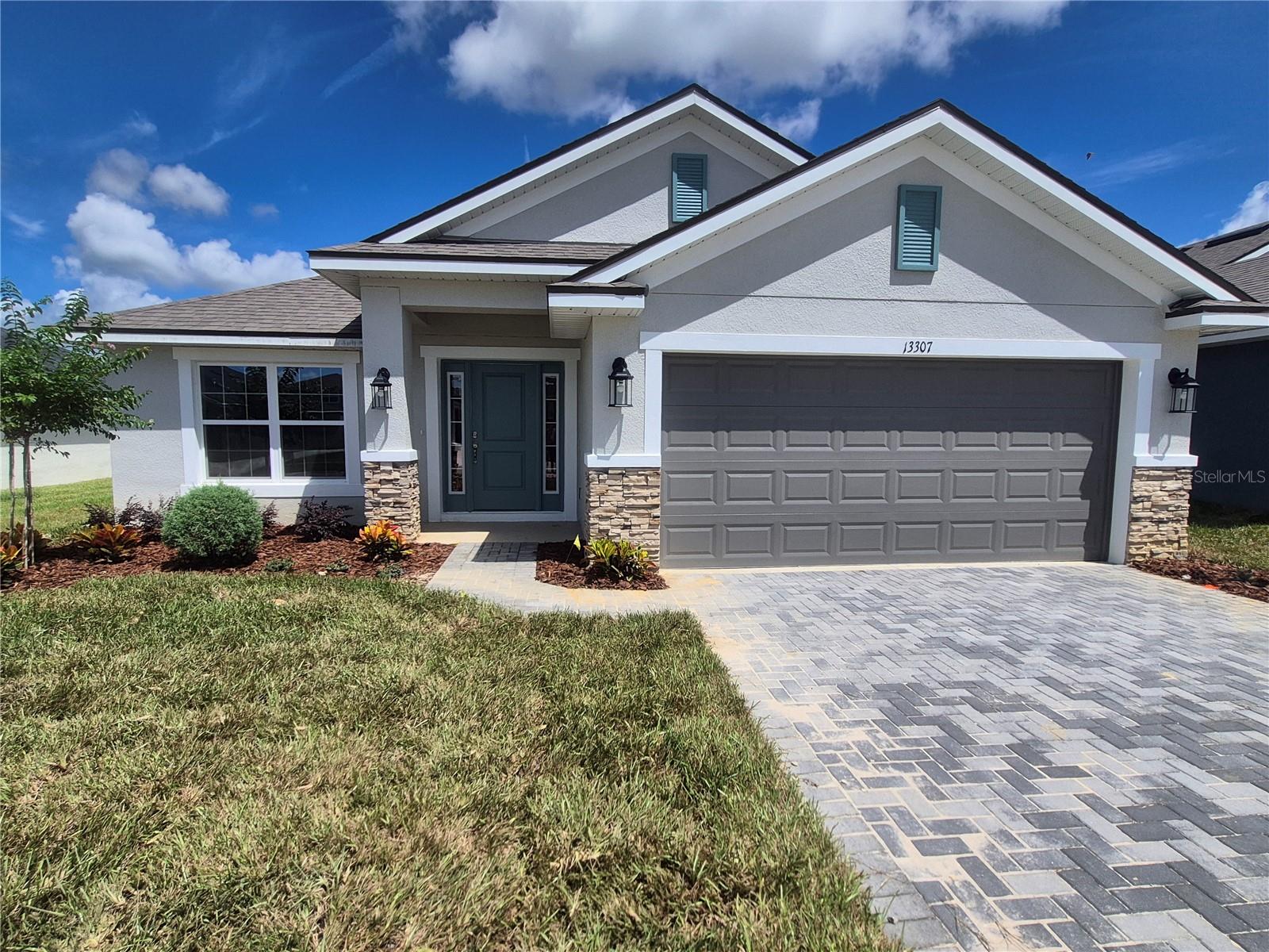 PRICE REDUCTION !! Welcome to Abbey Glen—Dade City’s hidden gem with NO CDD fees and all the charm of brand-new construction! This spacious 4-bedroom, 3-bath home offers 2,200 sq ft of thoughtfully designed living space, with every bedroom featuring its own walk-in closet for maximum storage and style. Bedroom 2 includes a private en-suite bath, making it perfect for guests or multi-generational living. The heart of the home—your kitchen—shines with granite countertops, soft-close cabinetry, stainless steel appliances, and a seamless flow into open-concept living areas with elegant plank tile flooring. All three bathrooms echo the home’s upscale feel with matching granite counters and soft-close cabinetry. The primary suite is a true retreat, highlighted by a tray ceiling with crown molding and a stunning tiled shower with glass enclosure. Additional upgrades include 5¼” baseboards, a 50-gallon water heater, double-pane low-E windows, and the peace of mind that comes with no flood zone concerns. Why wait to build? Your brand-new home in Abbey Glen is ready now—beautifully finished, energy efficient, and move-in ready.