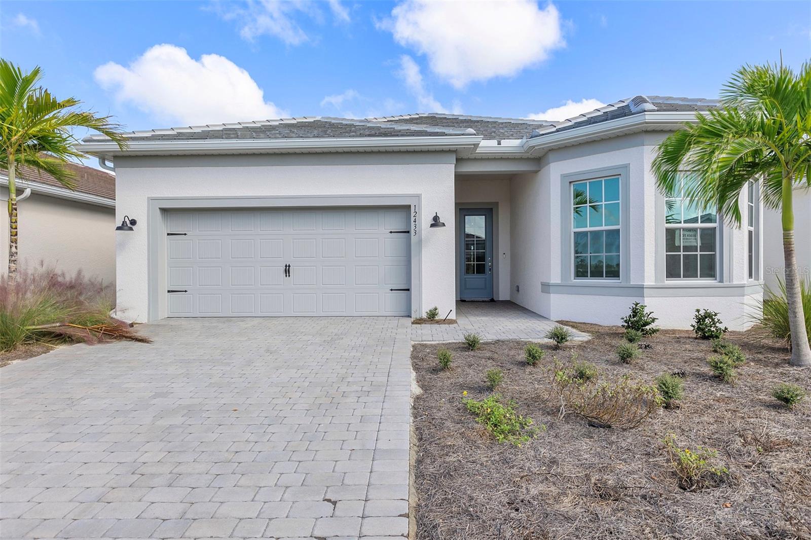 Available now a Lakespur at Wellen Park! This new construction, 2 bed 2 and a half bath home sits on a homesite with landscape views! It doesn't get much better than this. The Prestige plan offers an efficient single-story layout with great flow from room to room. The centrally located kitchen lets you enjoy casual breakfasts in the café or sunlit extended covered lanai. The flex room can serve as a den, home office, or third bedroom. The open-concept layout seamlessly connects the living room, cafe, and kitchen, making it perfect for entertaining guests or enjoying cozy evenings at home. Upgrades include built in KitchenAid appliances, quartz countertops with gorgeous calcutta mosiac backsplash, tray ceiling at the gathering room and owners suite, outdoor kitchen pre plumb, laundry cabinets and countertops, oversized garage and much more! Lakespur at Wellen Park, located in Venice, Florida, is the perfect place to call home for those seeking a vibrant lifestyle with coastal charm. This gated community will feature 68 future homesites and is part of Wellen Park, an award-winning master-planned community known for its thoughtful design and dynamic amenities. Residents will enjoy close proximity to world-class golf courses, pristine Gulf Coast beaches, and a variety of dining and shopping options. Within the community, residents can take advantage of a private amenity center featuring a resort-style pool, a cozy fire pit lounge, an event lawn, a playground, a fenced-in dog park, and a 12-foot-wide paved walking trail perfect for morning strolls or evening bike rides. Beyond Lakespur, Wellen Park itself offers even more, including schools, retail centers, a splash pad, scenic lakes for kayaking, and miles of trails.