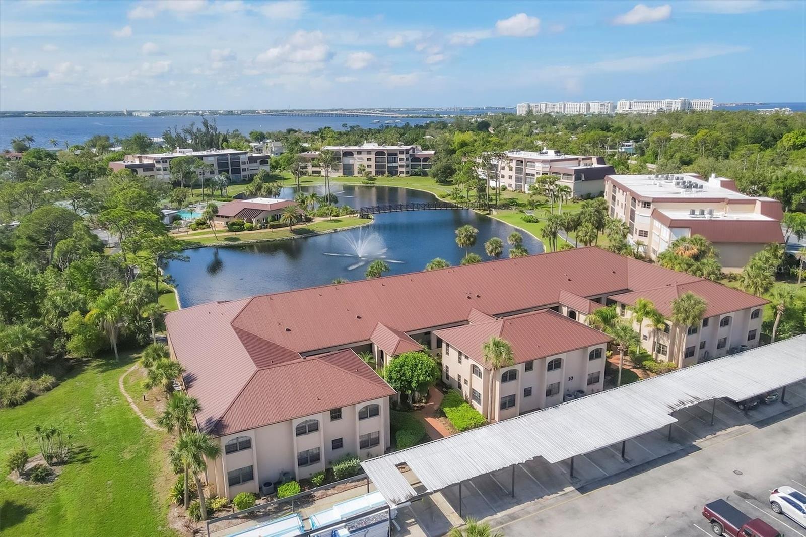 Welcome to this unit that LOOKS AND SHOWS LIKE A MODEL!! Step in to this 2nd floor end unit condo and you immediately feel like your home. LVP flooring throughout for ease of cleaning, spacious living/dining room combo layout with sliders to balcony overlooking the treetops. The galley style kitchen is a delight with eat in area as well as ship lap ceiling and walls, crown molding, closet pantry, plenty of cottage style white cabinetry, quartz counters and stainless appliances. Primary suite has neutral, tranquil colors with walk in closet with organizers, en suite bath with dual sinks atop a beautiful furniture style vanity and step in tiled shower. Down the short hall you'll find the guest bedroom right past the 2nd bath. Adjacent to dining area is your closet laundry area with washer/dryer included. What a bonus to have plantation shutters on almost every window in the unit except slider and bedroom 2. This is the only two story building in Rolls Landing so no worries about more fees for structural integrity inspections now required for over 2 stories. Docks are available on a first come, first serve basis for a low annual fee, and storage lot for trailer also has low annual fee per seller. You can also take advantage of the private boat ramp. For your enjoyment there is a community pool, tennis courts and more. Your monthly fee includes water, sewer and basic cable charges. Rolls Landing is located with easy access in either direction to US 41 in one direction and I75 in the other which allows you access to shopping, dining, medical and so much more. This unit shows like the epitome of living in Paradise with that sunny, cottage feel. Do yourself a favor and call to see today, you'll be glad you did!!