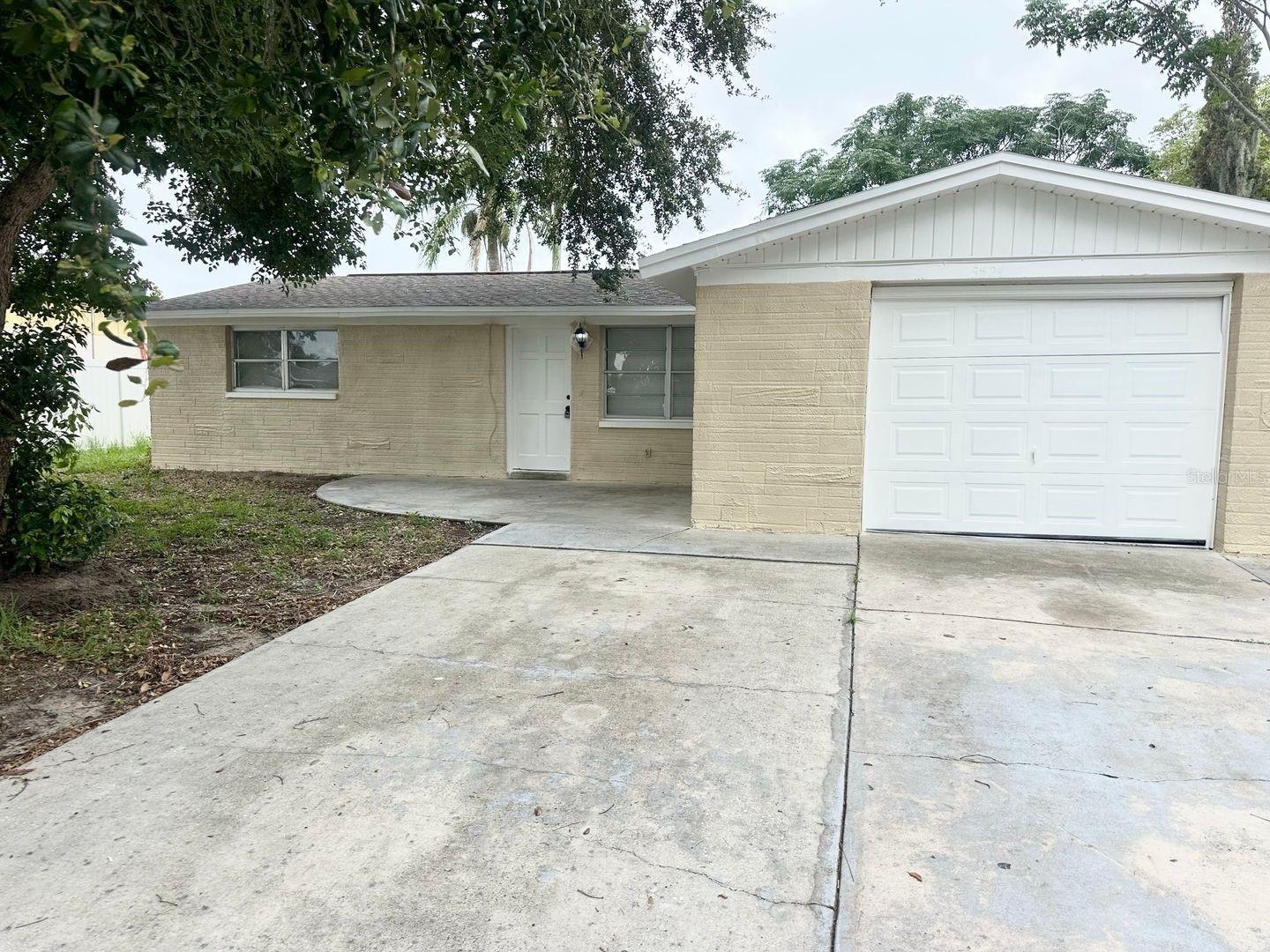 This updated 4 bedroom, 2 bath house includes a 1-car garage and is for rent in Holiday. This home features ceramic tile throughout and plenty of windows which allow for a ton of natural light! The kitchen features newer cabinets and countertops and includes a stove and fridge. The bathrooms have updated vanities, mirrors and fixtures. Centrally located near US 19 for a quick commute. You will be near the Tarpon Springs Sponge Docks, lots of local shopping, restaurants and beaches like Fred Howard Park.