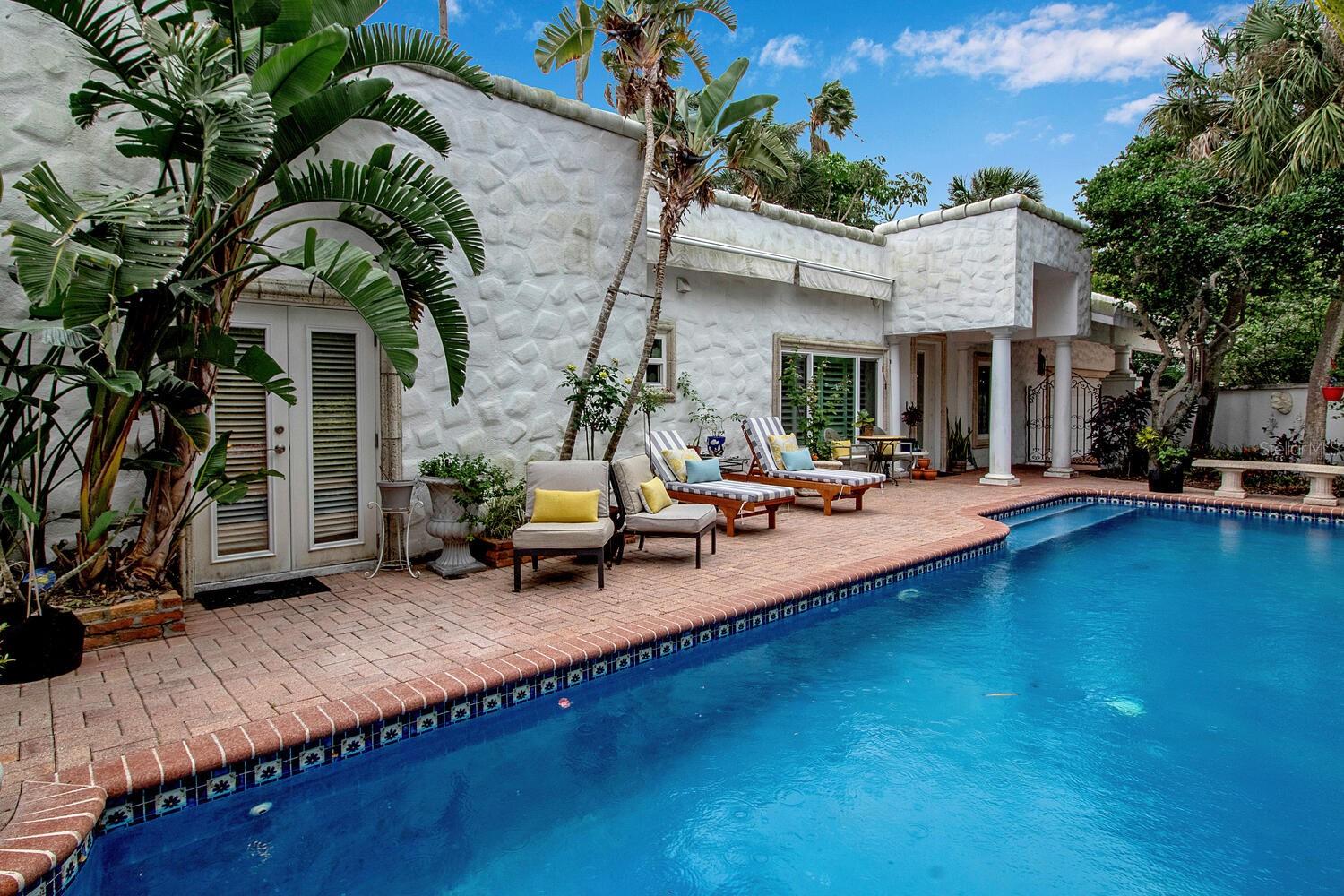 OWNER WANTS IT SOLD! NEW ROOF 11/2023! A "One of A Kind Shangri-La" on St Armand's Key! Magnificent walled estate on the first layer of residential homes on S Blvd of the Presidents. Don't just live "on the Circle" - live "IN THE CIRCLE"! Very well kept home with more than ample parking - but you won't need a vehicle. Very private setting with a lap pool for relaxation, meditation or exercise. Short stroll to Lido Beach and even shorter to St Armand's Circle that's just outside your front main gate. Oversized master bedroom with TWO bathrooms and a private outdoor shower. Tons of privacy, loads of convenience, lots of upgrades and easy to maintain!