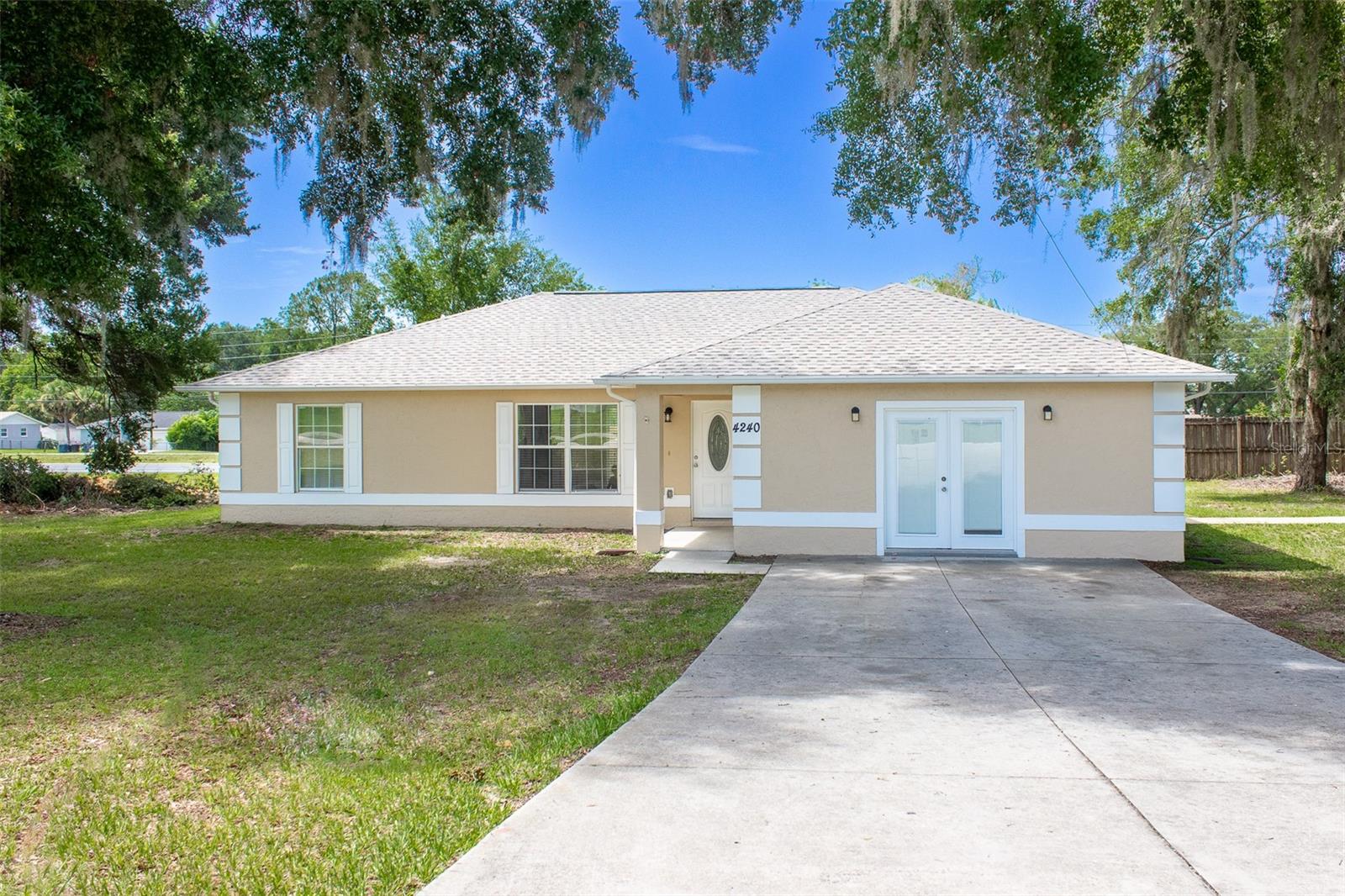 Welcome to this beautifully maintained home nestled on a spacious .37-acre lot in Belleview Heights Estates. Thoughtfully updated, this property offers 1,760 square feet of comfortable living space, the versatile 460 sq ft 4th bedroom/flex room is perfect for a home office, media room, guest suite, or whatever suits your lifestyle. The split floor plan provides added privacy, making it ideal for multi-generational living or visiting guests. Step inside to find stunning porcelain tile flooring throughout, offering both elegance and durability, and enjoy the peace of mind that comes with a very recent new roof. The home also features a convenient inside laundry room, keeping chores tucked neatly out of sight. Outside, a covered garage port protects your vehicles, and the oversized lot gives you plenty of room to relax or entertain. Best of all, you're just minutes from shopping, medical facilities, and a variety of restaurants. Convenient living without the hassle of HOA rules. This is Florida living made easy.