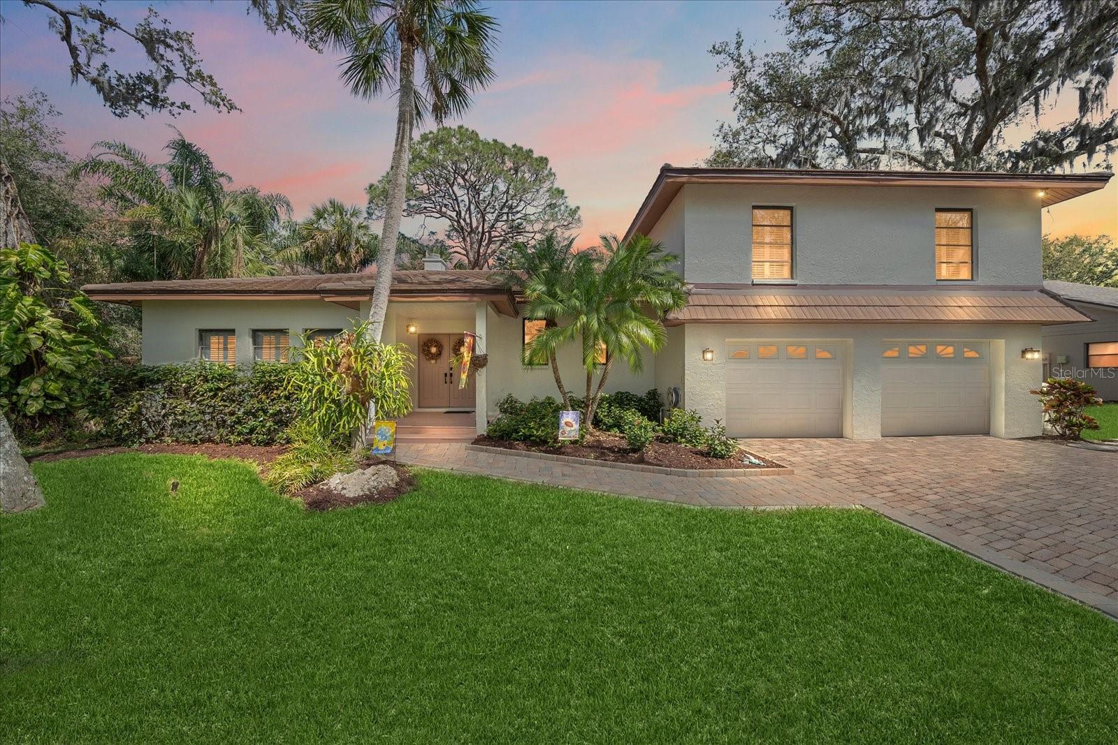 This is the one you've been waiting for! The Florida lifestyle in an updated home on a cul-de-sac street in one of Sarasota's most iconic neighborhoods. Halfway between downtown and the interstate, you are close to everything that Sarasota has to offer yet secluded in the tree lined streets of Sherwood Forest. This custom built, well-maintained home with a newer tile roof (2017) offers modern updates and functional living spaces. The split-level plan features three zoned AC units (2022)(2025), a new water heater, bar refrigerator, washer, dryer all (2024), and pool pump (2025). The interior and exterior were freshly repainted in 2025 along with all new doors and hardware throughout the home. The spectacular pool area was refinished in 2023 with a 10-year warranted pool surface and spa and includes an almost 1,000sf brick paver pool deck along with a raised deck and a panoramic screened-in pool cage with 10-foot ceilings. Inside, the remodeled kitchen features granite countertops, an island gas cooktop with exterior ventilation through a range hood, an electric double oven, and a pass-through window to the deck for easy outdoor dining. There is also an eat-in kitchen area with stacked sliders leading to the raised deck, making entertaining a breeze and providing seamless indoor-outdoor living. A formal dining room off the living room is perfect for dinners and holiday gatherings. The upstairs bedrooms feature beautiful hardwood floors and updated bathrooms. The zen-like owner’s bathroom was remodeled in 2018 and includes a walk-in shower with a rainfall showerhead and massage jet system, quartzite countertops, custom cabinetry, dual sinks, a private toilet closet, marble floors and plenty of storage. The ground level includes a fantastic laundry room with custom cabinetry and shelving, granite countertops, a built-in utility sink and tile floors. The ground level also includes a family room with a built-in bar and cabinetry with refrigerator, stacked sliders that lead on to the pool deck and a half-bath for convenience. The home also features crown mouldings throughout the house, a beautiful, fully functioning fireplace, polished marble flooring, plantation shutters on all windows, skylights, and hurricane panels for all the windows. There is also a central vacuum system and the home is wired for an alarm system. This home is ready for a new owner with all major updates completed! This quiet deed restricted neighborhood of Sherwood Forest which boasts majestic, mossy Oak trees that line the privately owned winding streets of the subdivision. There is a nostalgic covered bridge over the creek that graces the subdivision adding to its charm with the convenience of access to shopping and dining near-by, straight shot to downtown Sarasota, access to I-75, and Siesta Key Beach.