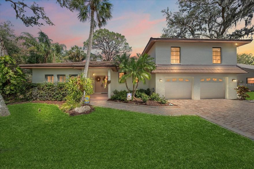This is the one you've been waiting for! The Florida lifestyle in an updated home on a cul-de-sac street in one of Sarasota's most iconic neighborhoods. Halfway between downtown and the interstate, you are close to everything that Sarasota has to offer yet secluded in the tree lined streets of Sherwood Forest. This custom built, well-maintained home with a newer tile roof (2017) offers modern updates and functional living spaces. The split-level plan features three zoned AC units (2022)(2025), a new water heater, bar refrigerator, washer, dryer all (2024), and pool pump (2025). The interior and exterior were freshly repainted in 2025 along with all new doors and hardware throughout the home. The spectacular pool area was refinished in 2023 with a 10-year warranted pool surface and spa and includes an almost 1,000sf brick paver pool deck along with a raised deck and a panoramic screened-in pool cage with 10-foot ceilings. Inside, the remodeled kitchen features granite countertops, an island gas cooktop with exterior ventilation through a range hood, an electric double oven, and a pass-through window to the deck for easy outdoor dining. There is also an eat-in kitchen area with stacked sliders leading to the raised deck, making entertaining a breeze and providing seamless indoor-outdoor living. A formal dining room off the living room is perfect for dinners and holiday gatherings. The upstairs bedrooms feature beautiful hardwood floors and updated bathrooms. The zen-like owner’s bathroom was remodeled in 2018 and includes a walk-in shower with a rainfall showerhead and massage jet system, quartzite countertops, custom cabinetry, dual sinks, a private toilet closet, marble floors and plenty of storage. The ground level includes a fantastic laundry room with custom cabinetry and shelving, granite countertops, a built-in utility sink and tile floors. The ground level also includes a family room with a built-in bar and cabinetry with refrigerator, stacked sliders that lead on to the pool deck and a half-bath for convenience. The home also features crown mouldings throughout the house, a beautiful, fully functioning fireplace, polished marble flooring, plantation shutters on all windows, skylights, and hurricane panels for all the windows. There is also a central vacuum system and the home is wired for an alarm system. This home is ready for a new owner with all major updates completed! This quiet deed restricted neighborhood of Sherwood Forest which boasts majestic, mossy Oak trees that line the privately owned winding streets of the subdivision. There is a nostalgic covered bridge over the creek that graces the subdivision adding to its charm with the convenience of access to shopping and dining near-by, straight shot to downtown Sarasota, access to I-75, and Siesta Key Beach.