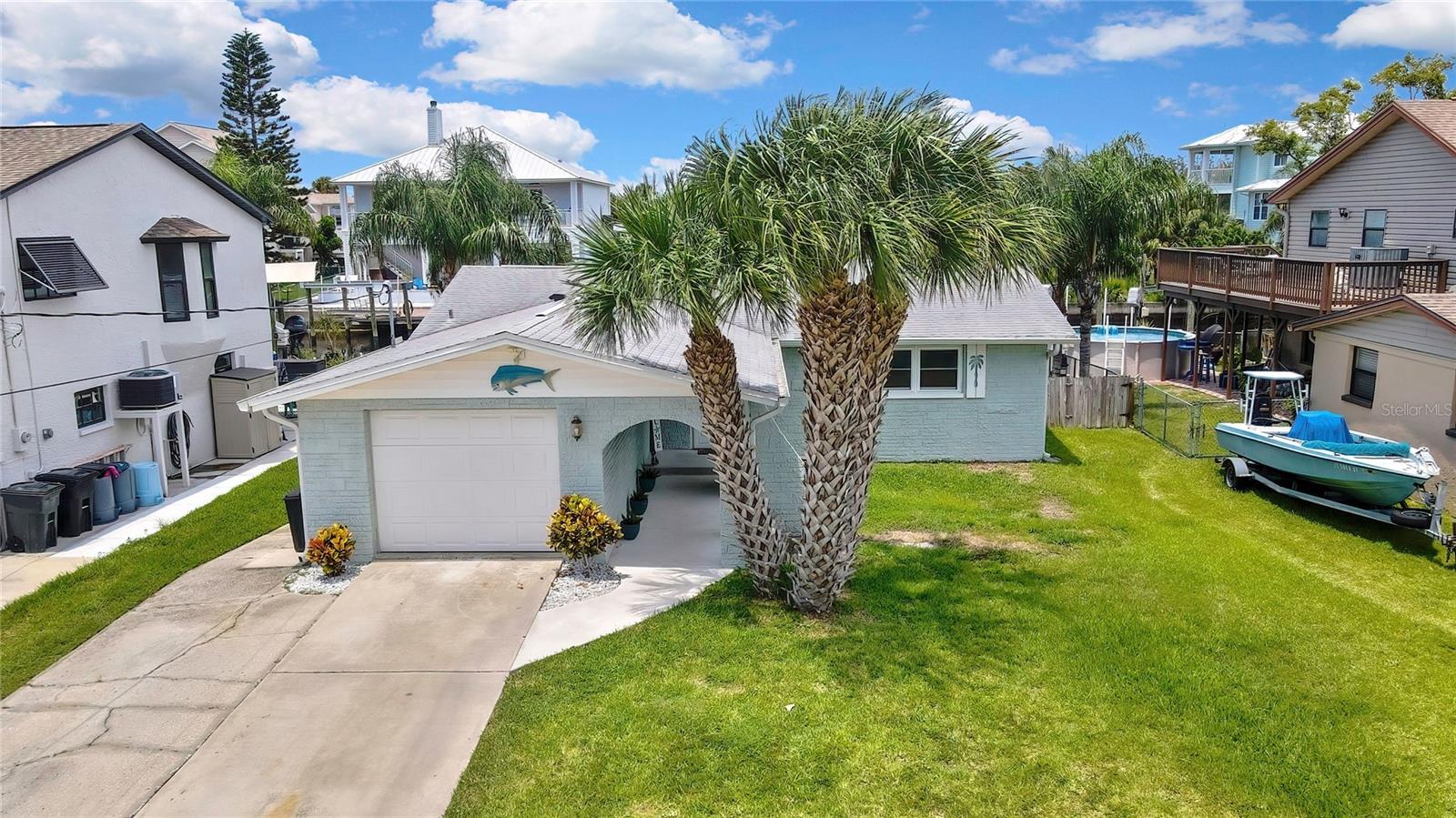COMPLETELY REMODELED ALMOST EVERYTHING NEW: This Waterfront 2-bedroom, 2-bathroom home W/Dock, and Lift (2022) in the sought-after Sea Pines community of Hudson, FL, is ready for you to move right in. As you approach the property, you will instantly love the tastefully chosen tropical color scheme and the fabulous custom glass front door. Upon entry, EVERYTHING YOU TOUCH IS NEW IN 2024/2025) All new Hurricane rated Double pane Impact winds 2024/2025) (AC is 2021) (ROOF IS 2016). All work done on the property has been fully permitted and completed by licensed Contract. You will be pleasantly surprised at the huge open floor plan. The seller has fully remodeled and expanded the Kitchen which is now a cooks dream w/ brand new appliances, The breakfast bar/island allows for even more cabinet and drawer space with the convenience of breakfast bar seating as well. This wide open concept allows you a beautiful view of the water from all of the living areas including the Primary bedroom. Floors are all new and beautiful luxury vinyl plank through out the entire area (2024/2025) The bedrooms and baths are wood look ceramic title. This home showcases modern and fresh design elements, offering a stylish and functional space to enjoy whether you are home year round or decide to do a short term rental during the away months for extra income. Fresh fishing daily could be easy and enjoyable, as you have direct access to the Gulf of America/Mexico right from your backyard. Boating enthusiasts will appreciate the 12 x 15 fixed dock made with composite decking as well as Vinyl dock piling wrap which will significantly extend the lifespan of the docs reducing the need for frequent repairs. The floating dock is also made of composite providing convenient on and off boarding. NOW LETS TALK ABOUT THE 10,000 pound BOAT LIFT complete with water, power, and a Seamule Flushmaster for those outboard Motor Flushes. This lift also is set with double bunks or can be removed for a Singe V-bottom boat. The north-facing rear patio offers both the spectacular sunrises and sunsets without overheating your lanai space creating an idyllic setting for outdoor living. The screened in Lanai will allow you to relax and take in the scenic surroundings. Don't want to go out on the salt water today? Well this home has you covered with your own little oasis complete with a pool to cool off in. They say Sea Pines, is the crown jewel of Hudson, where the allure of isolation meets the tranquility of coastal living. Tucked away down Old Dixie Hwy and surrounded by pristine marshland, Sea Pines stands out as the premier community in Hudson, offering residents a unique blend of seclusion and community spirit. What sets Sea Pines apart is its exclusive channel leading to the Gulf, meticulously maintained and marked by the Coast Guard, providing residents with convenient access to the open waters. A community boat ramp, available for a nominal fee/yr, adds to the appeal, making it a haven for boating enthusiasts who want to explore the Gulf's beauty at their leisure. Unlike many communities, Sea Pines operates as an optional civic association rather than a strict HOA, allowing residents the freedom to tailor their experience while fostering a sense of community without sacrificing individuality. Don’t miss this rare opportunity to own an affordable direct Gulf access home that really checks all the boxes. It is truly the gift that just keeps giving.