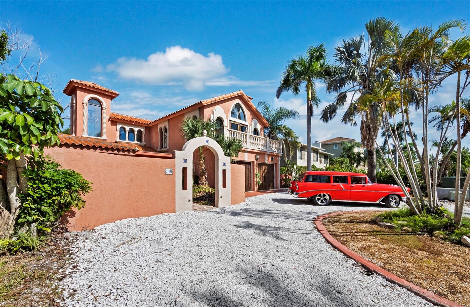 An extraordinary opportunity awaits the next visionary owner of this spacious waterfront Mediterranean-style home. Whether you choose to renovate the current home or build your new dream home, it is ideally located on a wide canal with no fixed bridges to the Gulf of Mexico. A day out on the water is right out of your back door! It is just a short stroll to the pristine beach in the highly desirable north end of Longboat Key. This is where luxury living meets the relaxed charm of coastal living. The home was damaged in the storms but was properly remediated and drywall was replaced. It features 3 bedrooms and 3 baths, and offers abundant space to recreate your perfect waterfront retreat. A distinctive arched entryway welcomes you to a private front courtyard. Upon entering through the beautifully carved wooden door, you are greeted by an abundance of natural light that highlights the unique architectural details, with a scenic view of the sparkling canal beyond. The first floor hosts a spacious open plan living and dining area, the kitchen, two bedrooms, and two bathrooms, along with a large utility room that could easily serve as a fourth bedroom or additional living space. A grand staircase leads to the primary bedroom, which boasts a luxurious marble ensuite with a jacuzzi tub and breathtaking views of the canal below. This exceptional room features a cathedral ceiling with exposed wooden beams, a gorgeous oak floor with intricate inlays, a wood-burning fireplace, and a balcony overlooking the private courtyard. It is a true sanctuary that could easily be transformed into a second expansive living area. Close to multiple restaurants, the fabulous St.Regis Resort and the world renowned St. Armands Circle…..and just a couple of bridges away from the cultural epicenter of downtown Sarasota……this is a rare offering to come and make your own!