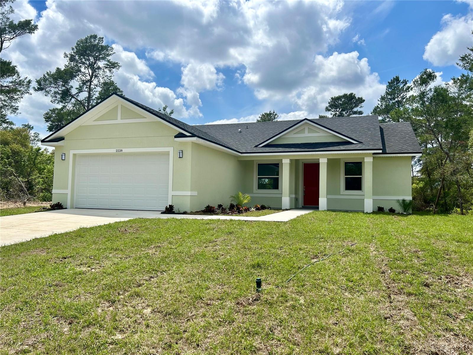 ** $4,000 towards Buyer’s closing costs or pre-paids** Exceptional New Construction in Marion Oaks! This captivating single-family home features 4 bedrooms and 2 bathrooms, providing an ideal haven for you and your family. Upon entering, you'll be captivated by the meticulous attention to detail and premium finishes that define this property. The open-concept living and dining area, adorned with high vaulted ceilings, is tailor-made for hosting gatherings. Step onto elegant vinyl floors that enhance the aesthetic of each room. The spacious kitchen boasts custom 42" wood cabinets, dazzling Quartz countertops, and a subway tile backsplash. The island offers both ample counter space and seating, complemented by a generous pantry for all your culinary essentials. Equipped with new stainless steel appliances, this kitchen is a culinary enthusiast's dream. The master bedroom, overlooking the rear patio, features a distinctive barn door entry to the ensuite bathroom. Revel in the luxury of dual sink Quartz vanity tops, a shower, and an expansive walk-in closet. The master bathroom is adorned with beautiful contemporary ceramic tile. Take advantage of the splendid Florida weather on your covered lanai and expansive backyard. This outdoor haven is perfect for entertaining, complete with an outdoor sink for added convenience. The 2-car garage provides ample space for your vehicles and extra storage. Don't miss the opportunity to call this remarkable property your own. Schedule a showing today to witness firsthand the modern luxury and comfort it offers. Its strategic location near supermarkets, schools, and major roads ensures easy access to all your needs. Make this must-see home yours today!